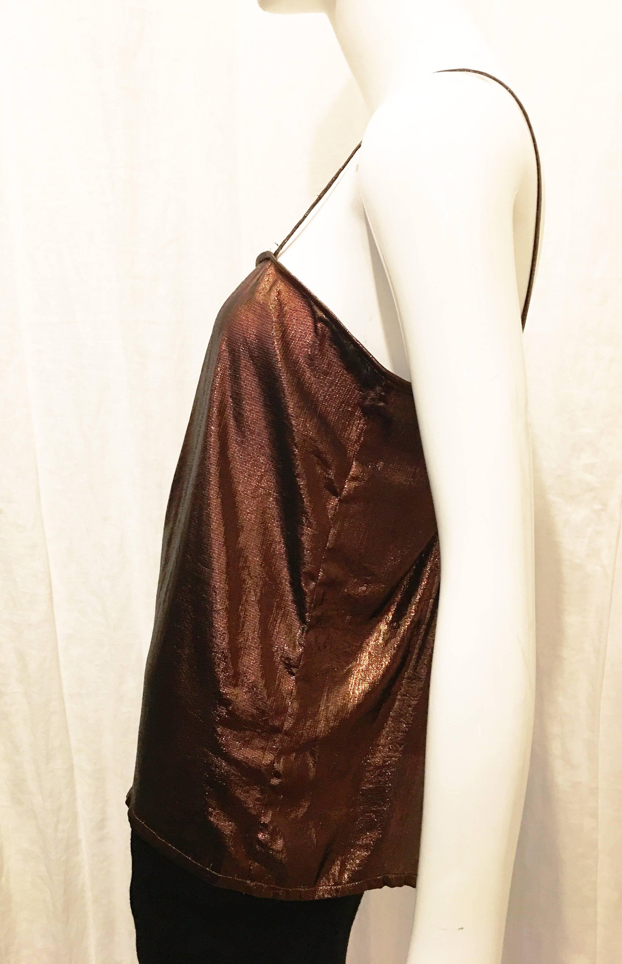 Bronze metallic spaghetti strap top with pleating at bust. Perfect layering piece. Wear with ankle length black slacks and a blazer for cocktail attire or with a mini skirt and heels for a night on the town. Beautiful warm tones in the light. 