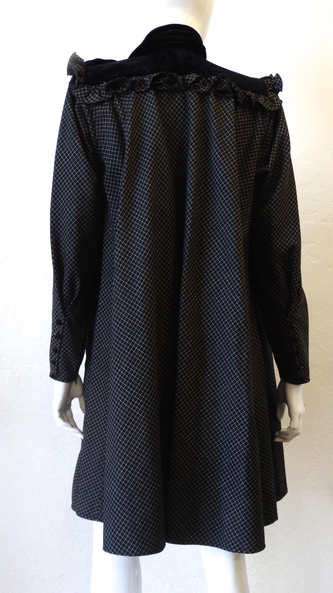 The Perfect 80s Dress Is Here! By Ungaro, this baby doll style dress displays a white checkered pattern and black decorative buttons down the front and on the outside of the cuffs. Leg O Mutton sleeves include zippers on the inside for a fitted