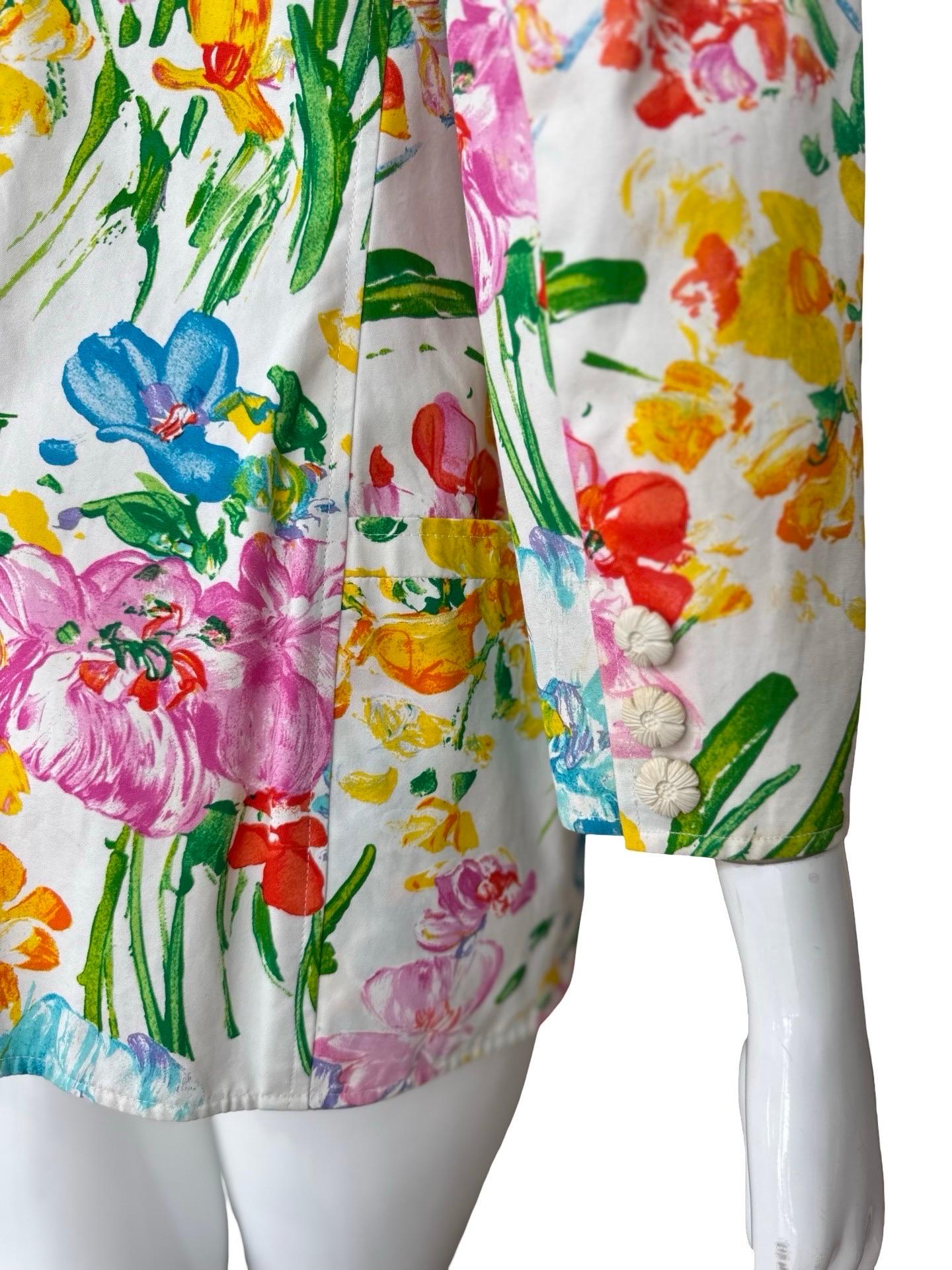 This is a bright and happy blazer sure to put a smile on your face when you wear it!  Done on a crisp white structured cotton  with a oil painted floral pattern in blue, green, pink, yellow and orange print.  The blazer is double breasted and is