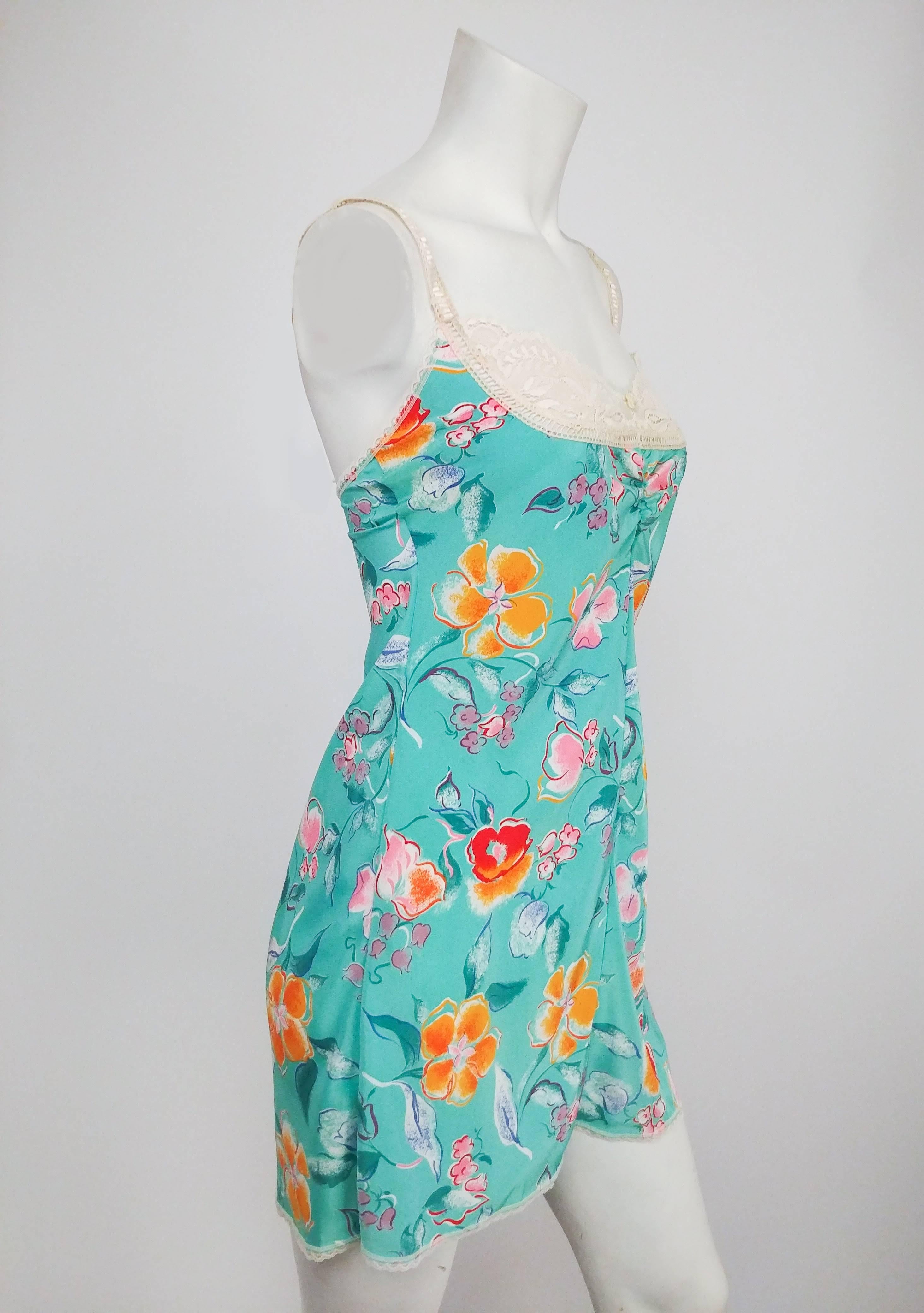 1980s Ungaro Seafoam Green Tropical Print Slip. Lace trim sweetheart neckline and ruched front bust. Lace adjustable straps. 
