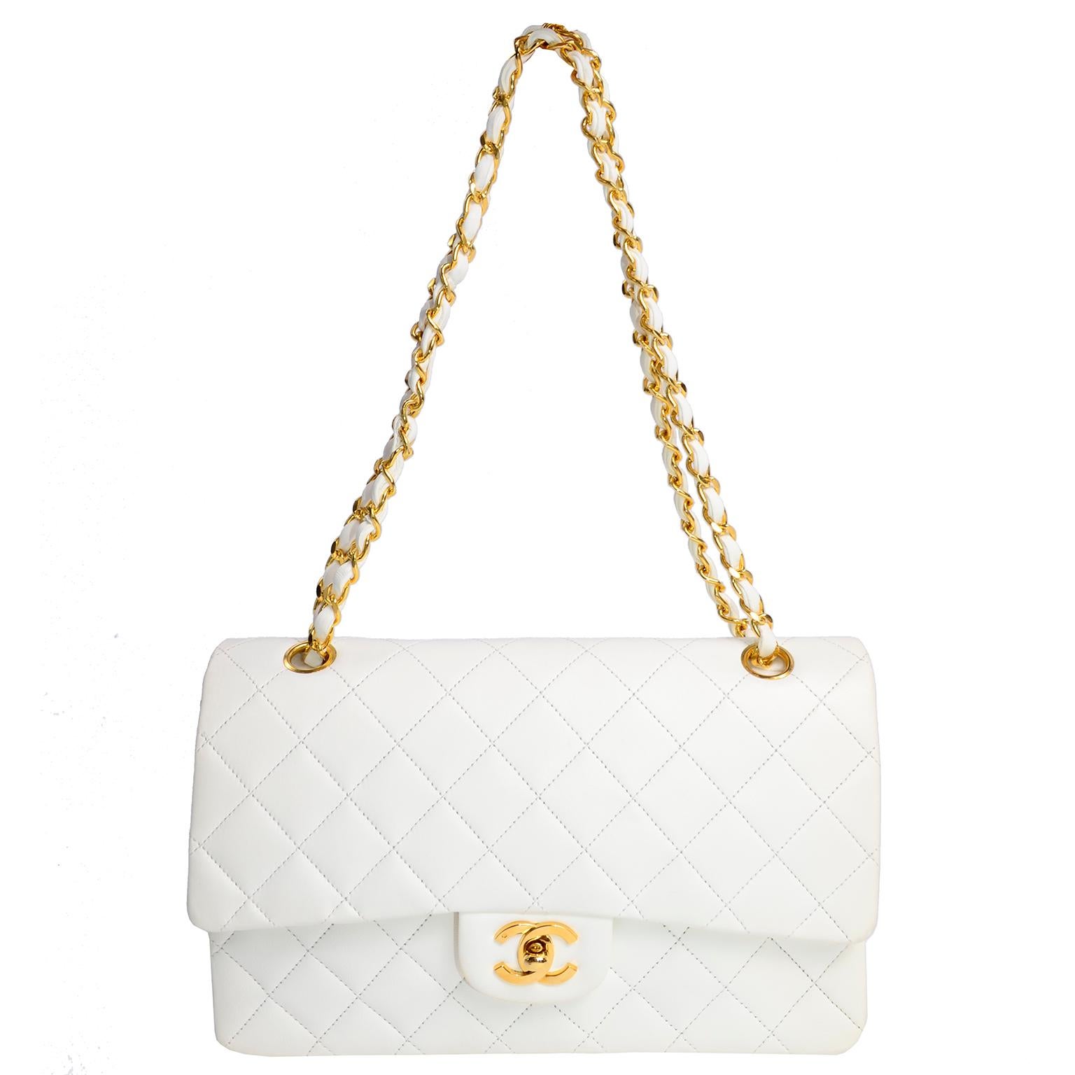 This is an unused vintage but new Chanel white quilted medium flap bag with its original tissue inside.  Beautiful gold hardware and leather and gold chain strap. The bag comes from a single owner who never used it and kept it with the original