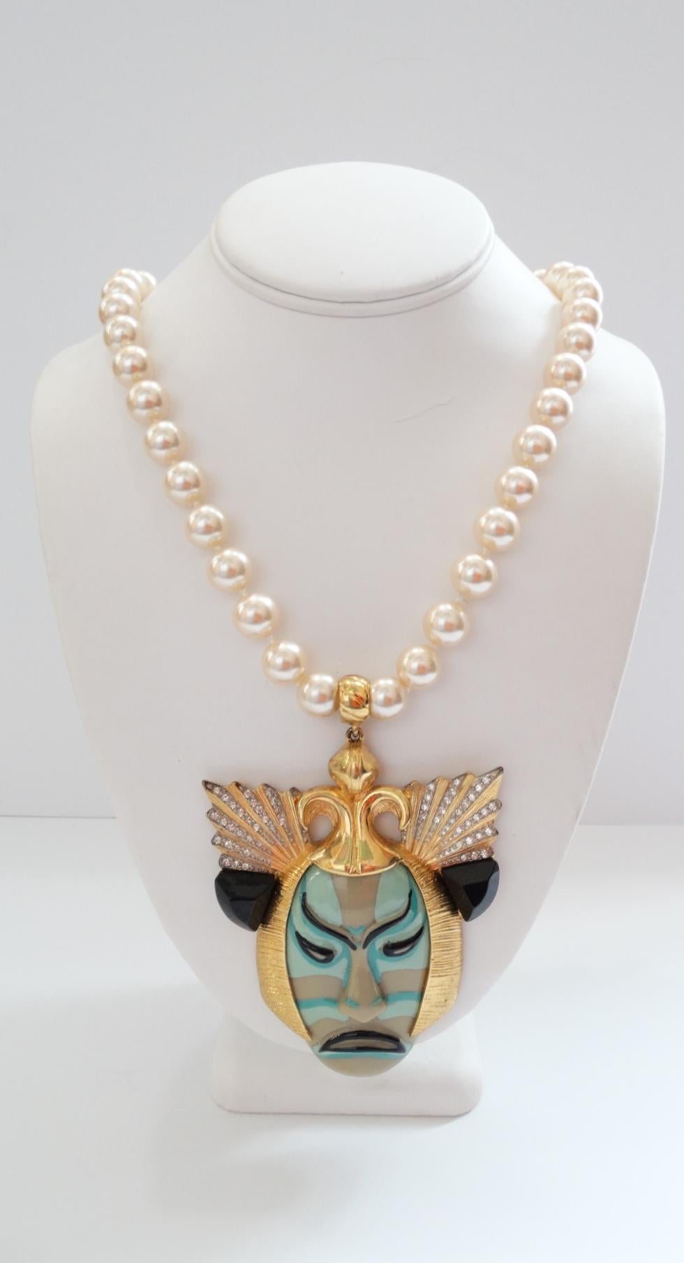 Make a statement with our incredible 1980s Samurai inspired pendant necklace from none other than the house of Valentino! Oversized mask-like pendant done up in the style of Ancient Samurai imagery- enamel glazed and gilded in a bright gold.