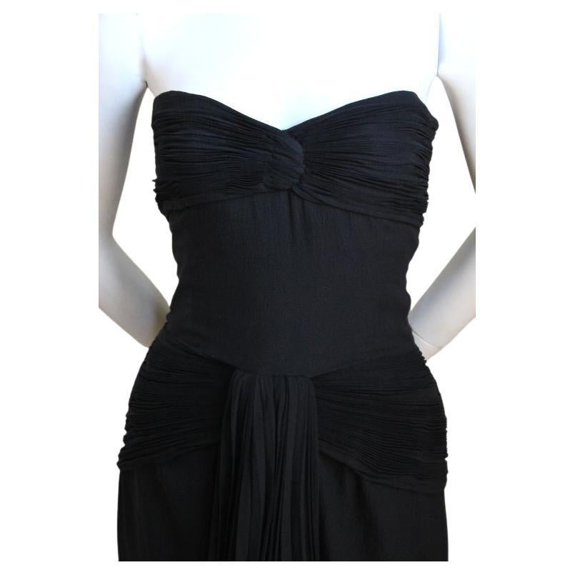 Jet-black, pleated , silk mini dress from Valentino Boutique dating to the early 1980's. Fits a size 6 or possibly an 8. Approximate measurements are: bust 36