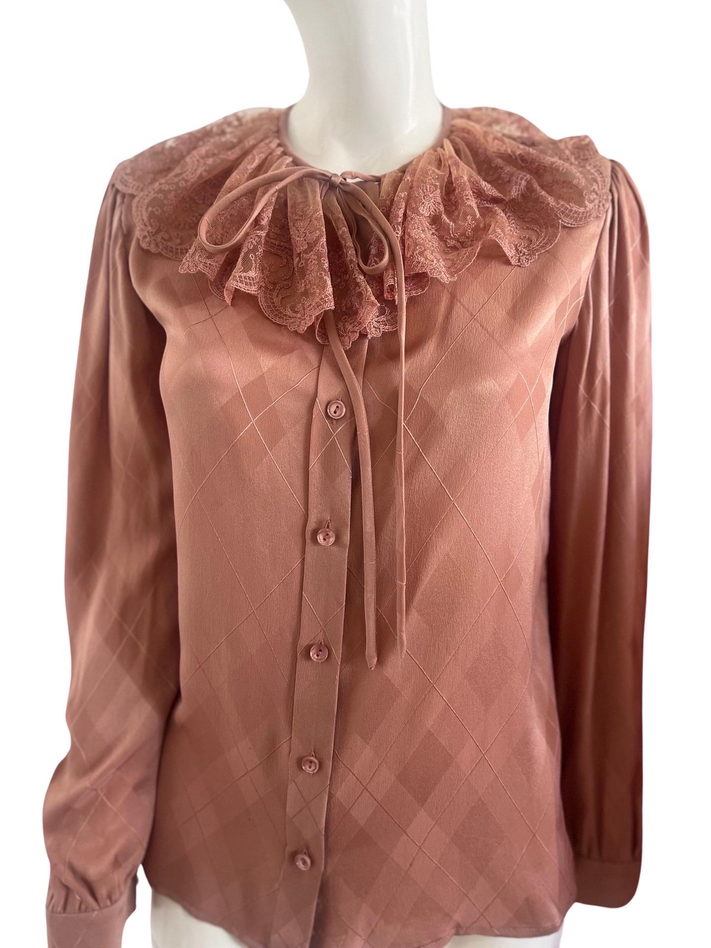 The most stunning 1980s Valentino blouse in a beautiful blush rose color pink silk in an Argyll print and a lace Peter Pan collar. Matching blush buttons and a tie in the front. Small shoulder pads easy to remove. Excellent condition, this looks to