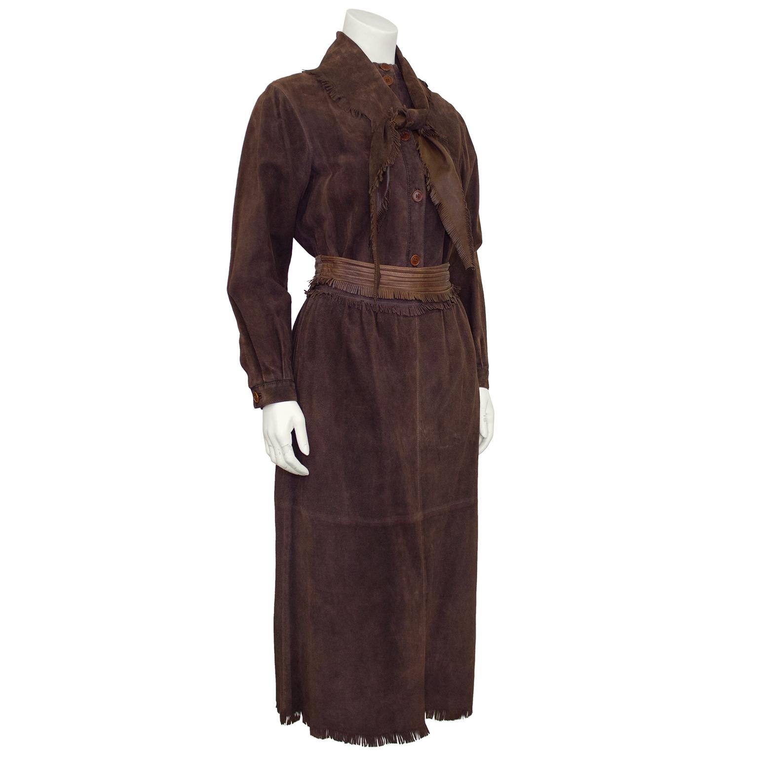 A beautiful butter soft brown suede and fringe Valentino ensemble from the 1980’s. Long button up shirt with a folded scarf collar that can be tied to your liking at the neck. High waisted midi length skirt with a contrasting brown leather ribbed