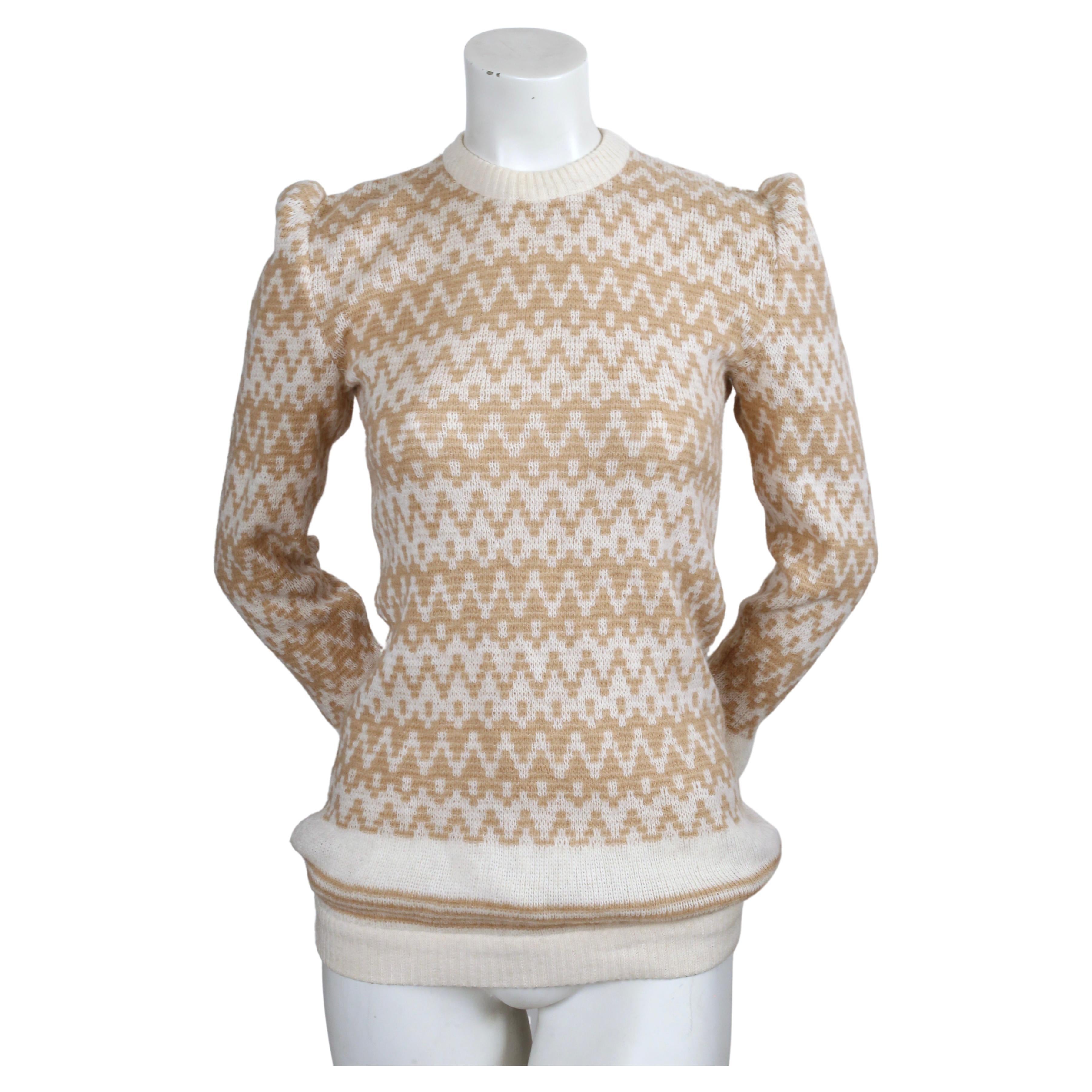 Cream and tan sweater with puff shoulders designed by Valentino dating to the early 1980's. Best fits an XS or S.  Approximate measurements (unstretched): bust 31