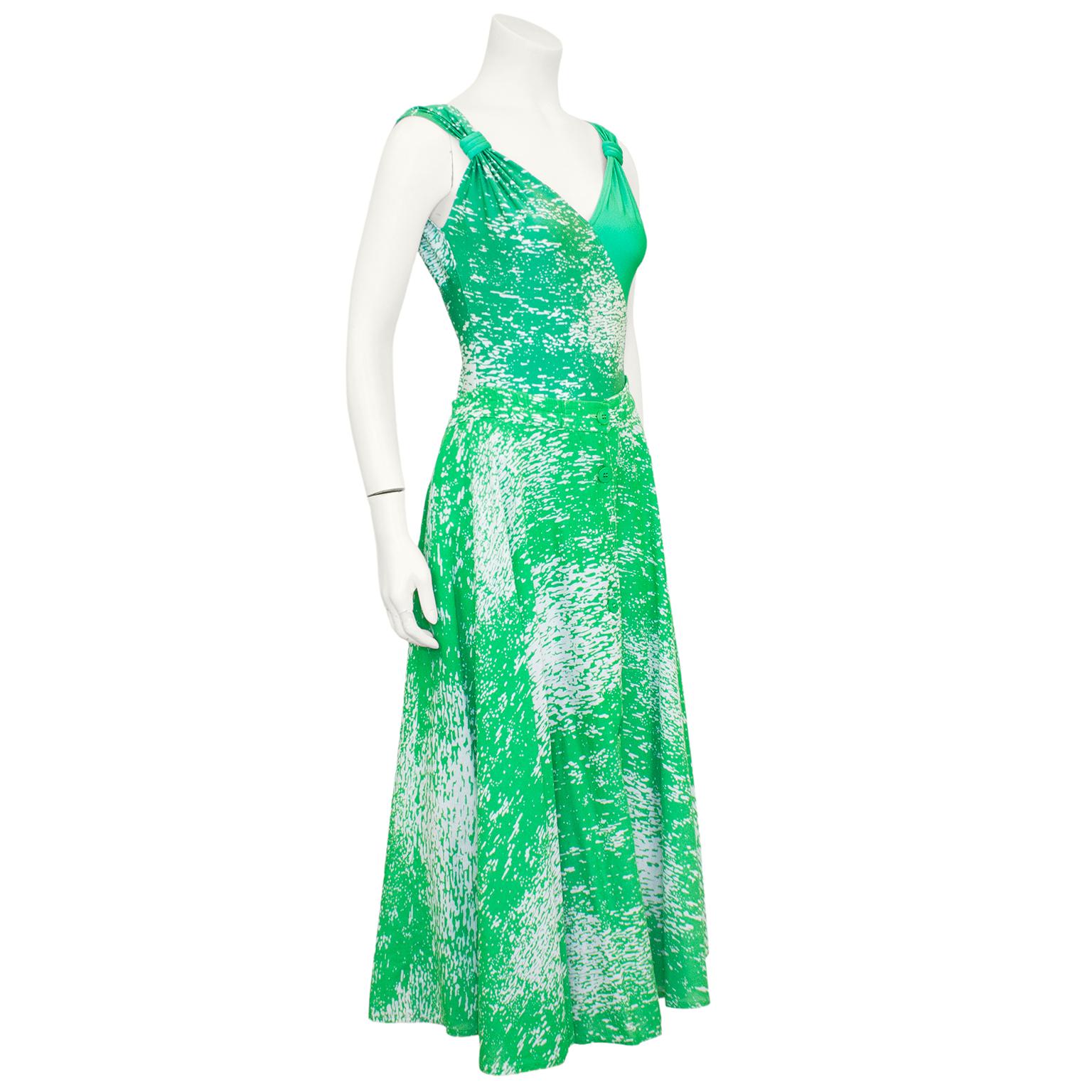 Fun and vibrant Valentino green and white printed acid wash ensemble from the 1980s. One piece bathing suit is half solid green and half printed with a v neck line and gathered straps. It can also be worn as a bodysuit. The matching circle skirt is