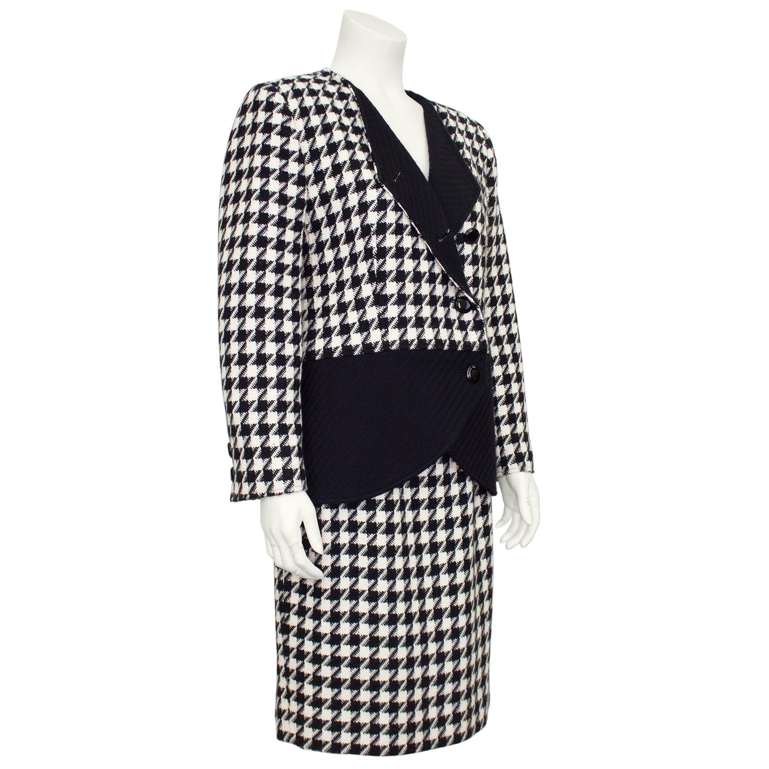 Chic 1980's Valentino large pattern black and white wool houndstooth suit with black scallop peplum and reverse turned notch collar. Below the waist double breasted closure, curved scallop cut on the front of the jacket.  Matching skirt with small