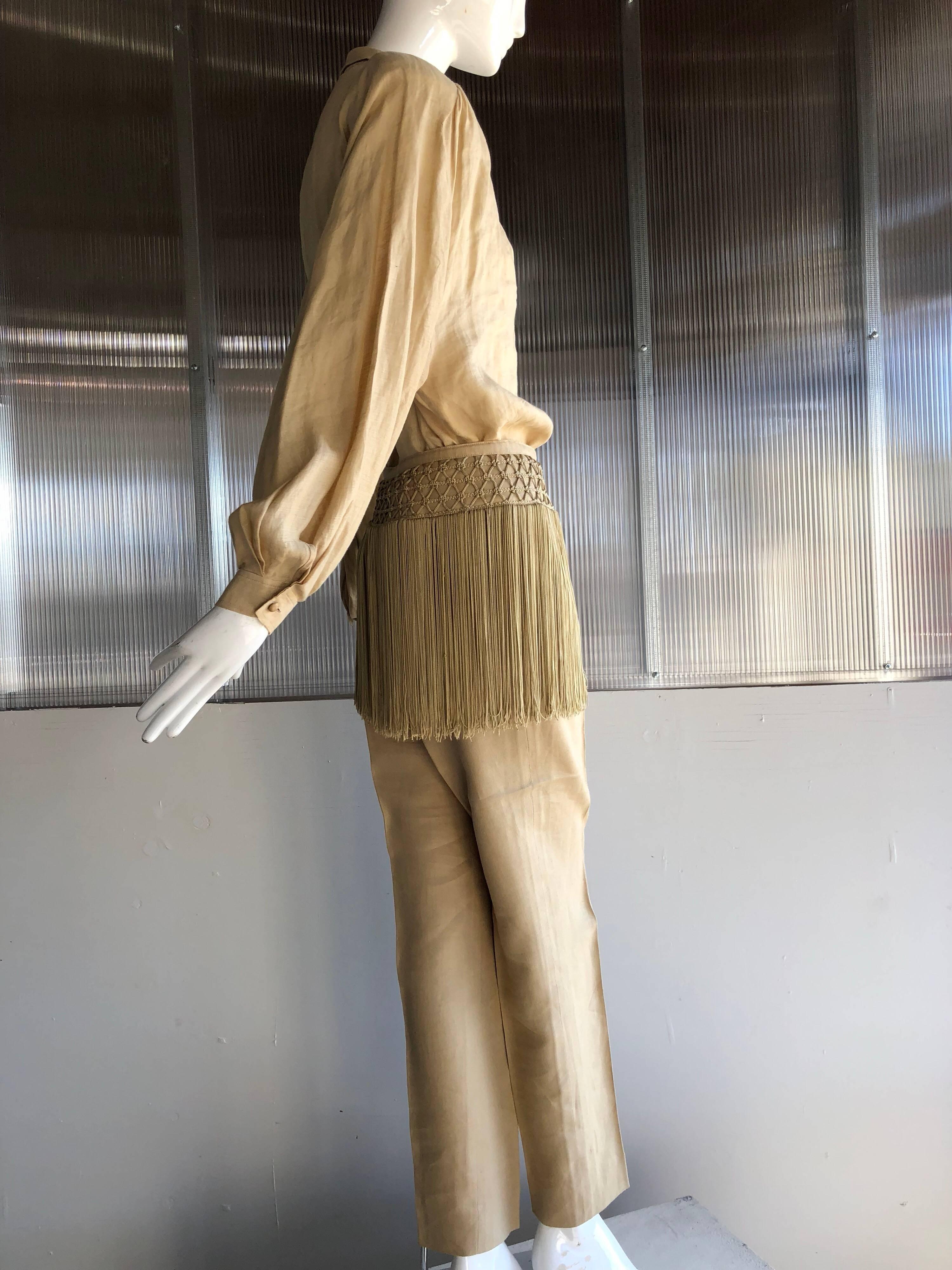 1980s Valentino parchment-color fine linen and fringe capri pant and tunic.  Top has padded shoulders and tucks into pants.  Heavy braided fringe waistband is attached to pant waist. 