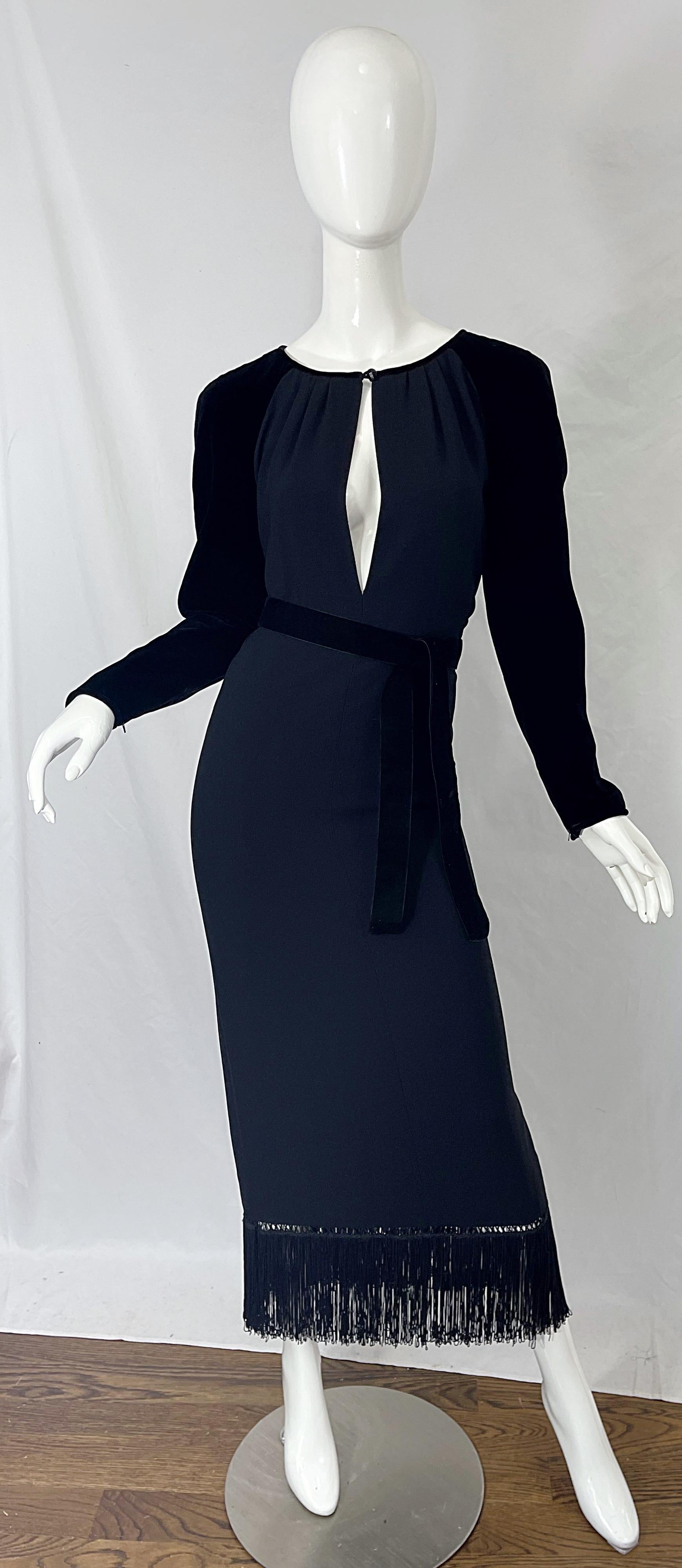 Unbelievable early 1980s VALENTINO black crepe and rayon and velvet sexy plunging open front fringed gown ! Features a crepe bodice with silk velvet long sleeves and matching velvet detachable belt. Open front plunging neckline with button closure.