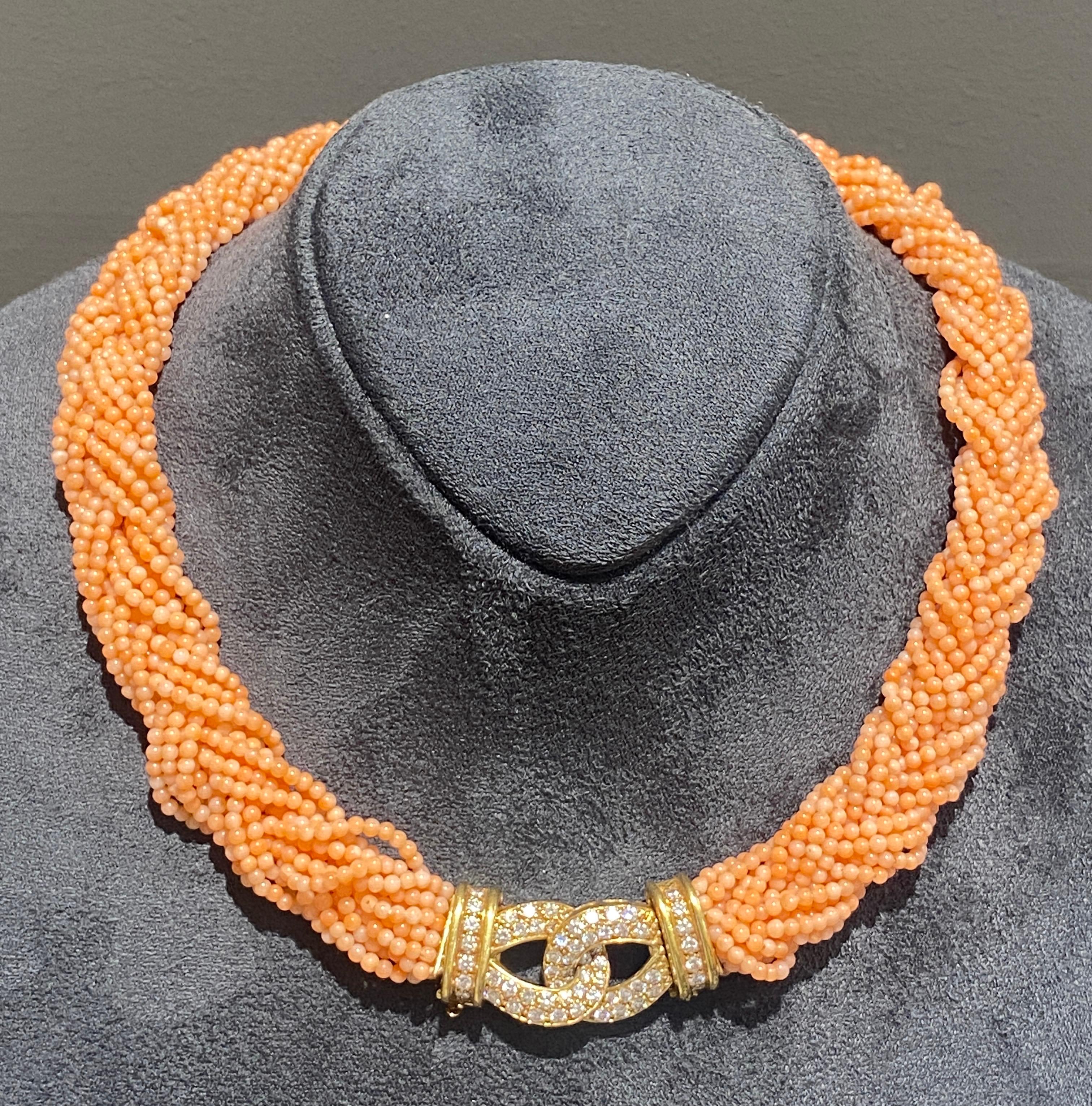This striking 1980s Van Cleef & Arpels coral and diamond necklace is beautifully made with a detachable 18 carat gold and diamond clasp that connects the plaited strands of coral. The ends of the coral strands are marked with VCA as is the 18 carat
