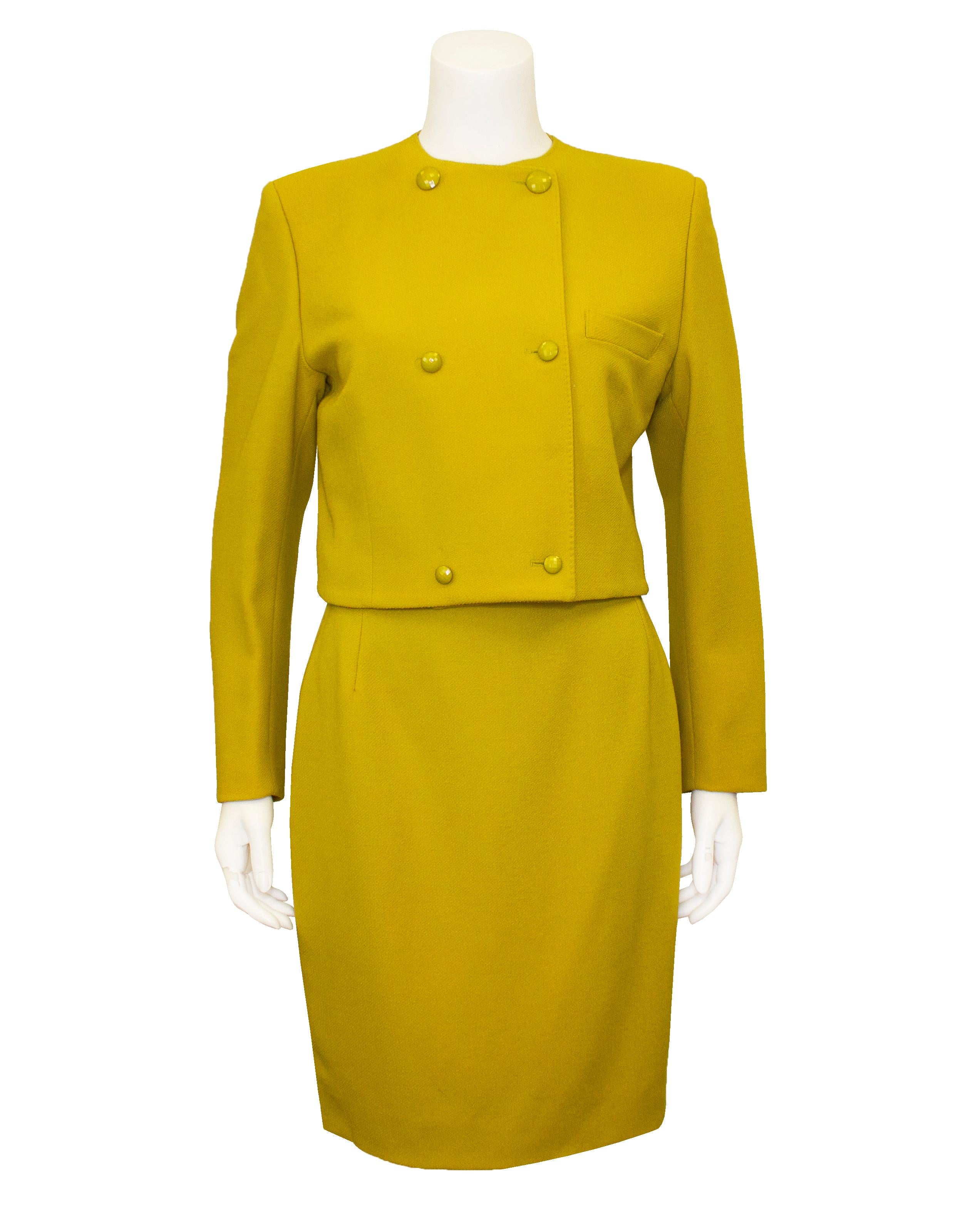 Very unique Gianni Versace three piece ensemble featuring a chartreuse wool scarf, jacket and skirt from the 1980s. The jacket is collarless, cropped and double breasted with a single slit pocket and matching plastic chartreuse buttons. The skirt is
