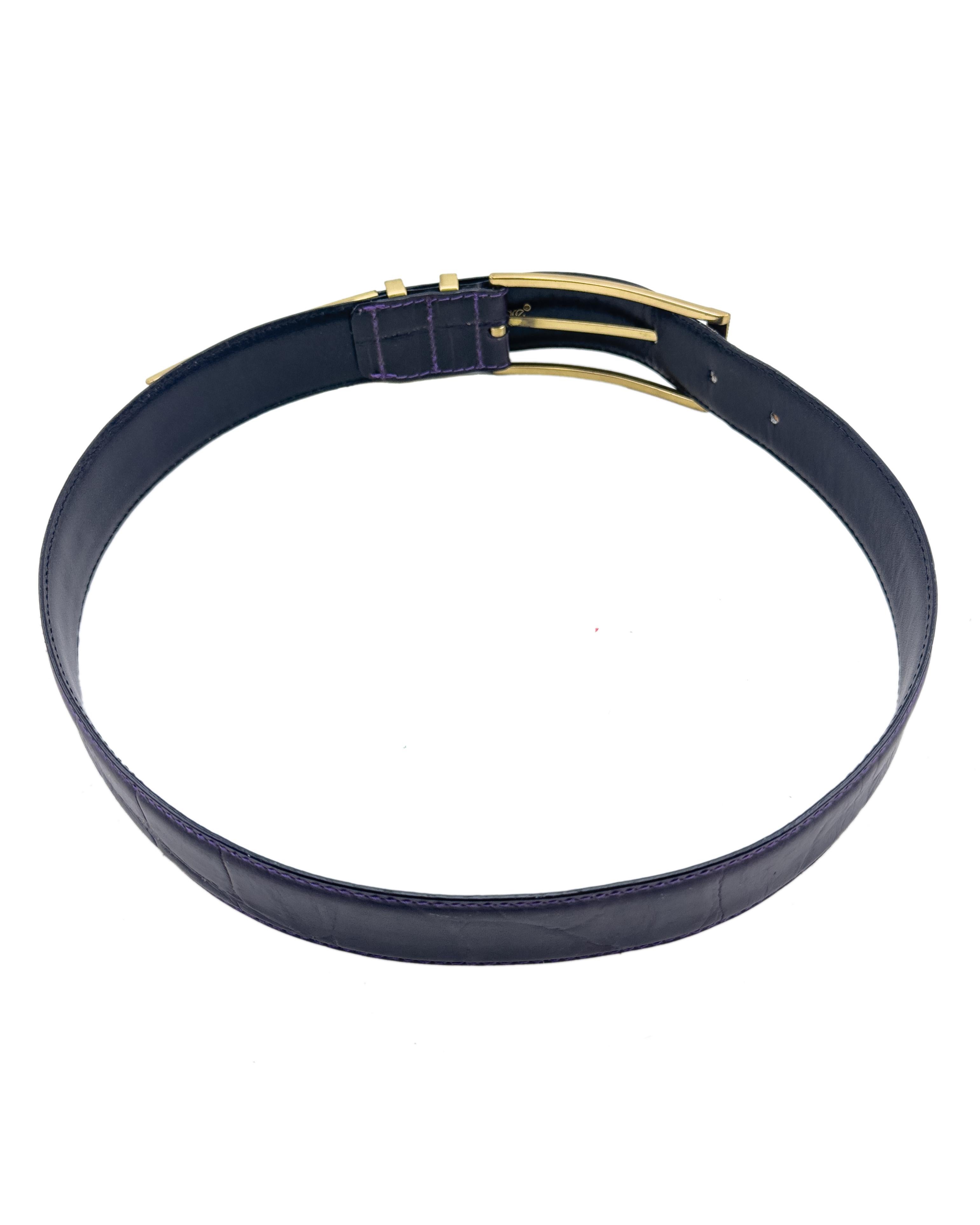 Fabulous Versace belt from the 1980s made from exquisite dark purple crocodile. The rich, deep purple hue is perfectly complemented against the polished gold-tone hardware, featuring ribbed double belt loops, an elegant pointed metal tip detail and