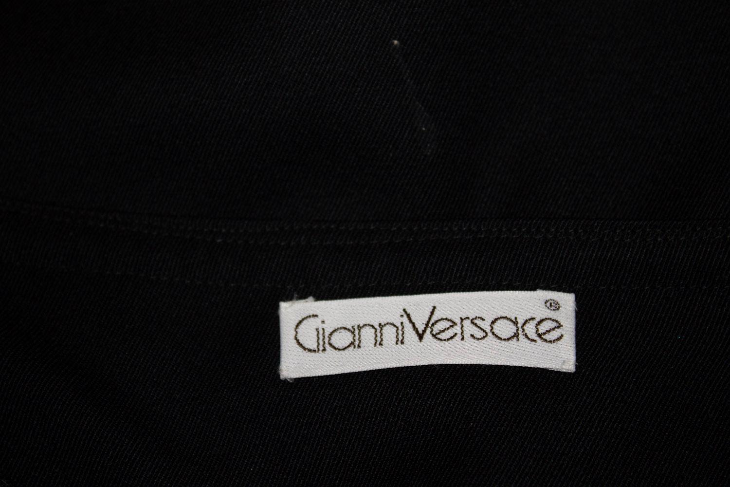 A great vintage skirt by Versace - mainline. 
In a black wool with a wide black leather waistband. The skirt has a fold over detail at the front with a wrap over with 2 button option.  It is fully lined. Size IT 42 , UK 34 .
waist band 6'' height.