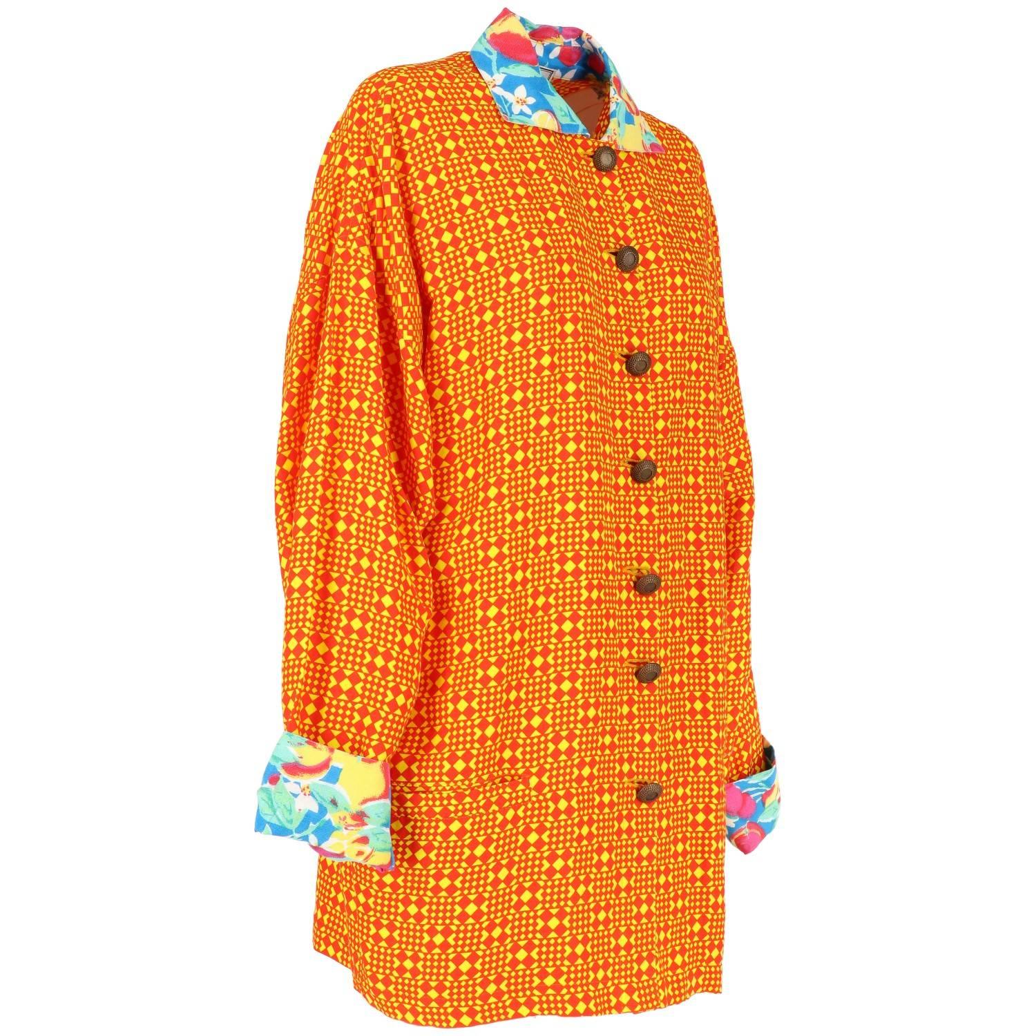 Vivid red and yellow cotton blend oversized Versace jacket. It features a geometric pattern, classic collar,  front buttons fastening, long sleeves and contrasting printed collar and cuffs. The item was produced in the 80s and it's vintage, in very