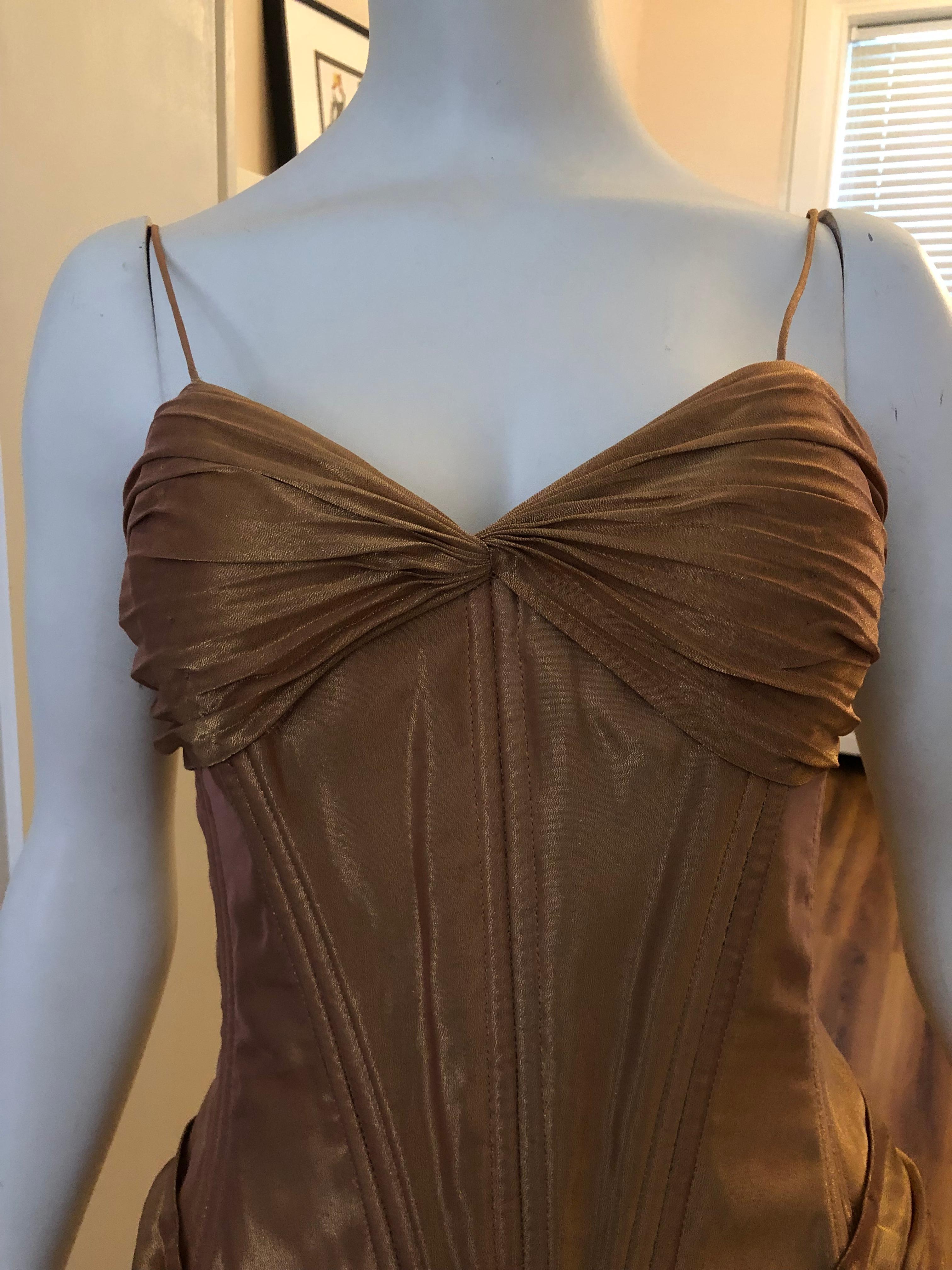 Outstanding piece in excellent condition. The dress is boned to the waist and has a an inset bra. The permanent pleats of the skirt complement the gathers to be found at the bust and waist. The bolero has gathered pleats at the collar and short