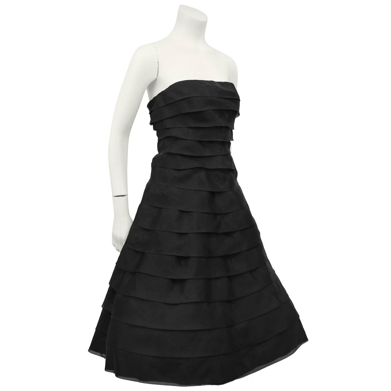 Stunning 1980s Victor Costa black strapless cocktail dress. Tiers of folded chiffon with a silver reflect throughout that catches the light beautifully. Boned bodice, with a-line tea length skirt with a linen underskirt with ruched black taffeta at