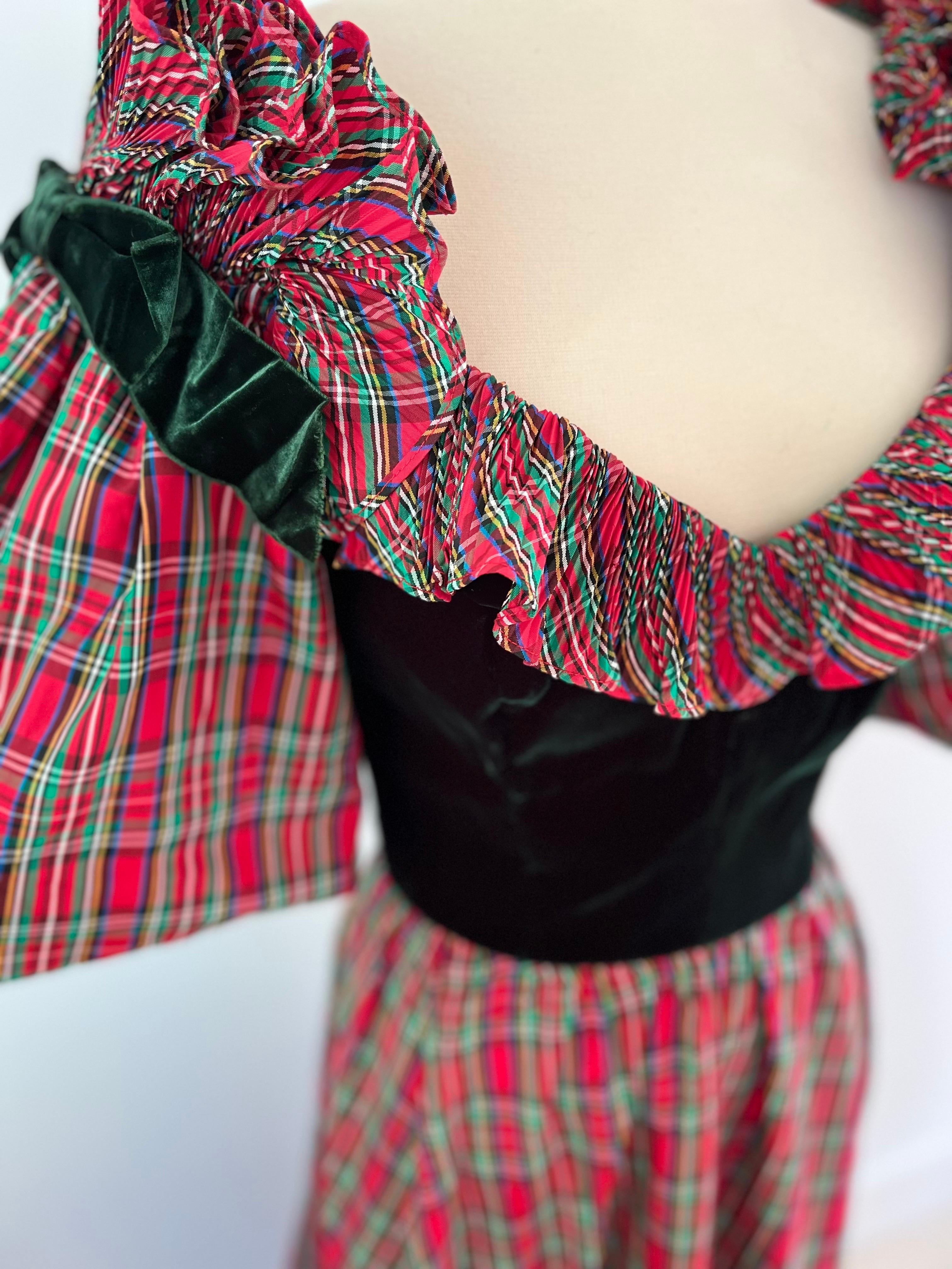 This dress is a holiday dream.  Like you stepped off the set of White Christmas.  A 1980s Victor Costa in red and green plaid taffeta with a full skirt and plisse ruffle hem at the bottom.  A dark forest green velvet fitted bodice  and big puff