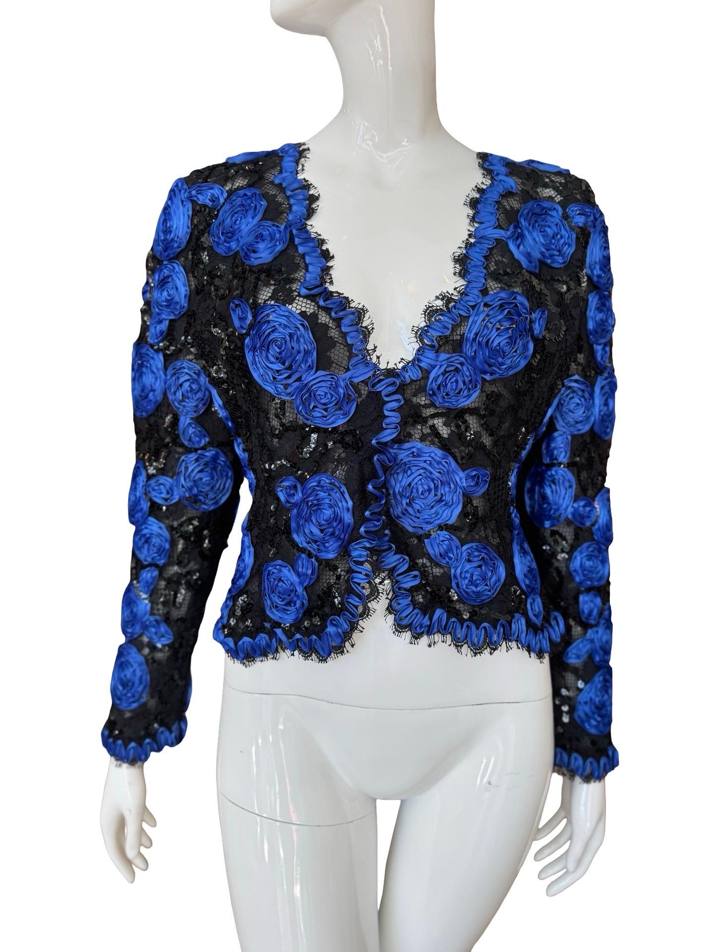 1980s Victor Costa evening glam jacket or bolero. Semi sheer with lace and a sheer lining, then decorated with blue ribbon rosettes and sequins snaked around the jacket.  Two hidden pop button for closure.   No size marked, best on a small to