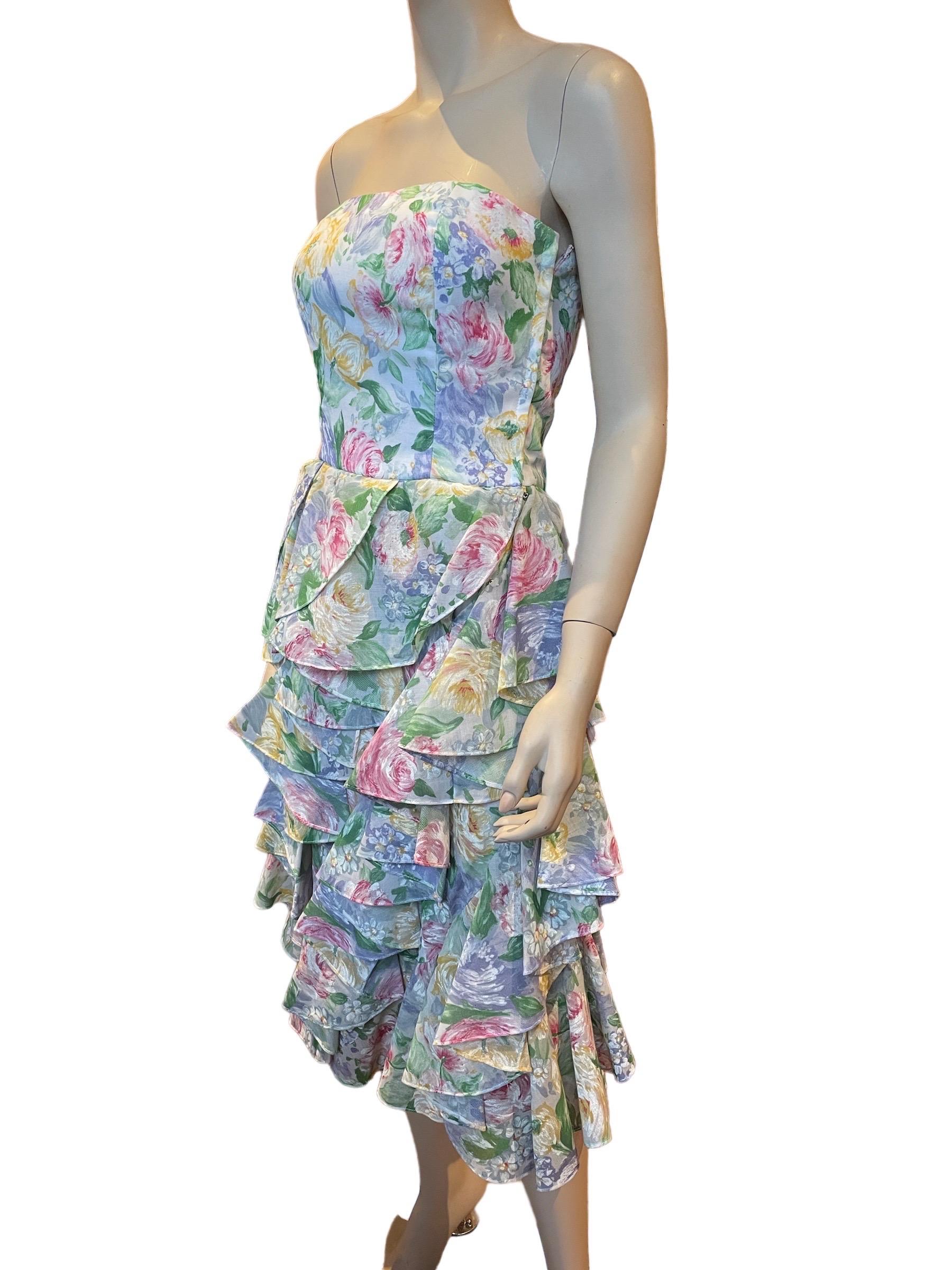 1980s Victor Costa Watercolor Floral Strapless Dress with Ruffled Skirt 

A beautiful floral dress with a structured bodice with boning and stuff tulle lined ruffles. 
