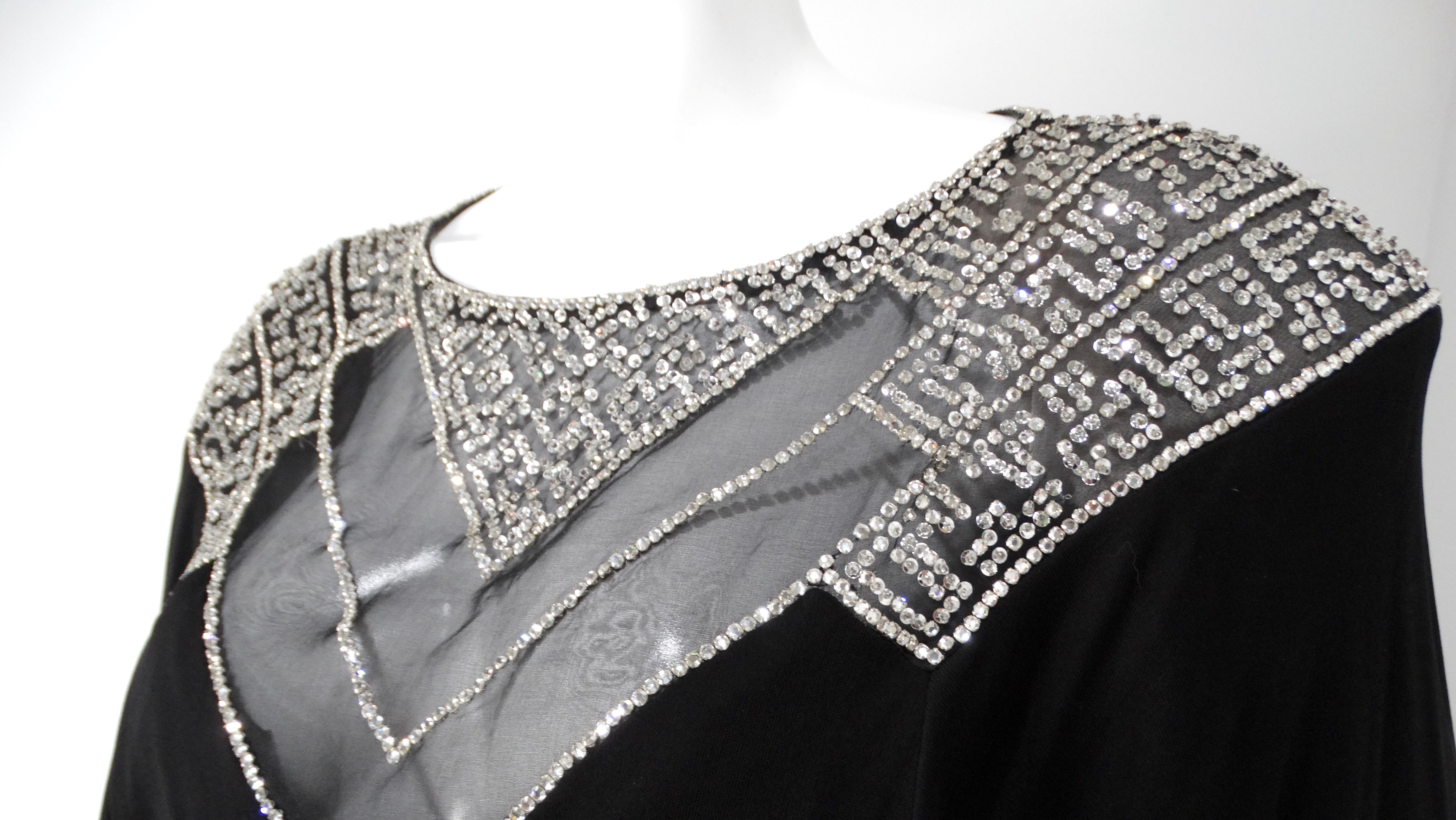 Step back into the glamorous 1980s with this exquisite Victoria Royal Rhinestone Dolman Evening Gown, a stunning representation of the era's bold fashion. This black long sleeve maxi dress boasts a dramatic silhouette, enhanced by flowing dolman