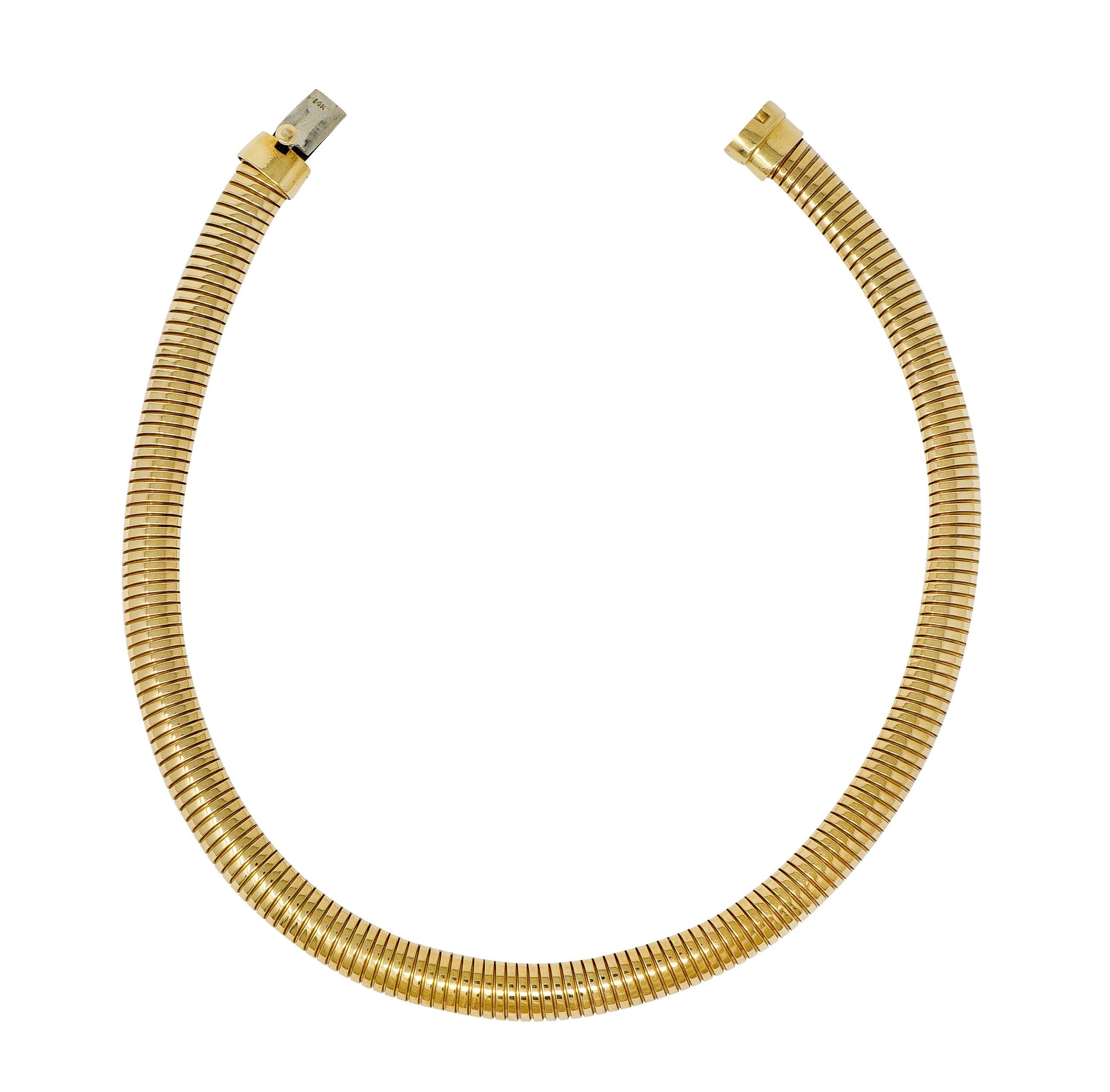 Collar style necklace designed with light and springy tubogas technology

Deeply ridged throughout with a bright finish

Completed by a concealed clasp with presser

Stamped 14K for 14 karat gold

Circa: 1980s

Length approx.: 13 3/4 inches

Width: