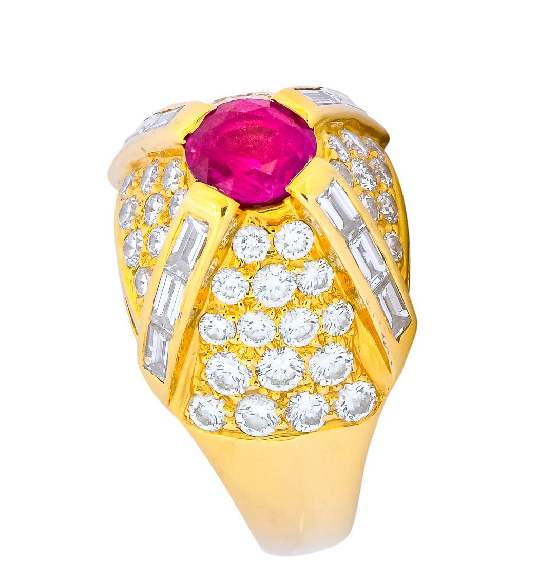 Bombé style ring centering a prong set round cut ruby weighing approximately 1.25 carats total, transparent pinkish-red color

Prongs are channel set with baguette cut diamonds weighing approximately 0.60 carat, G/H color and VS clarity

With pavé