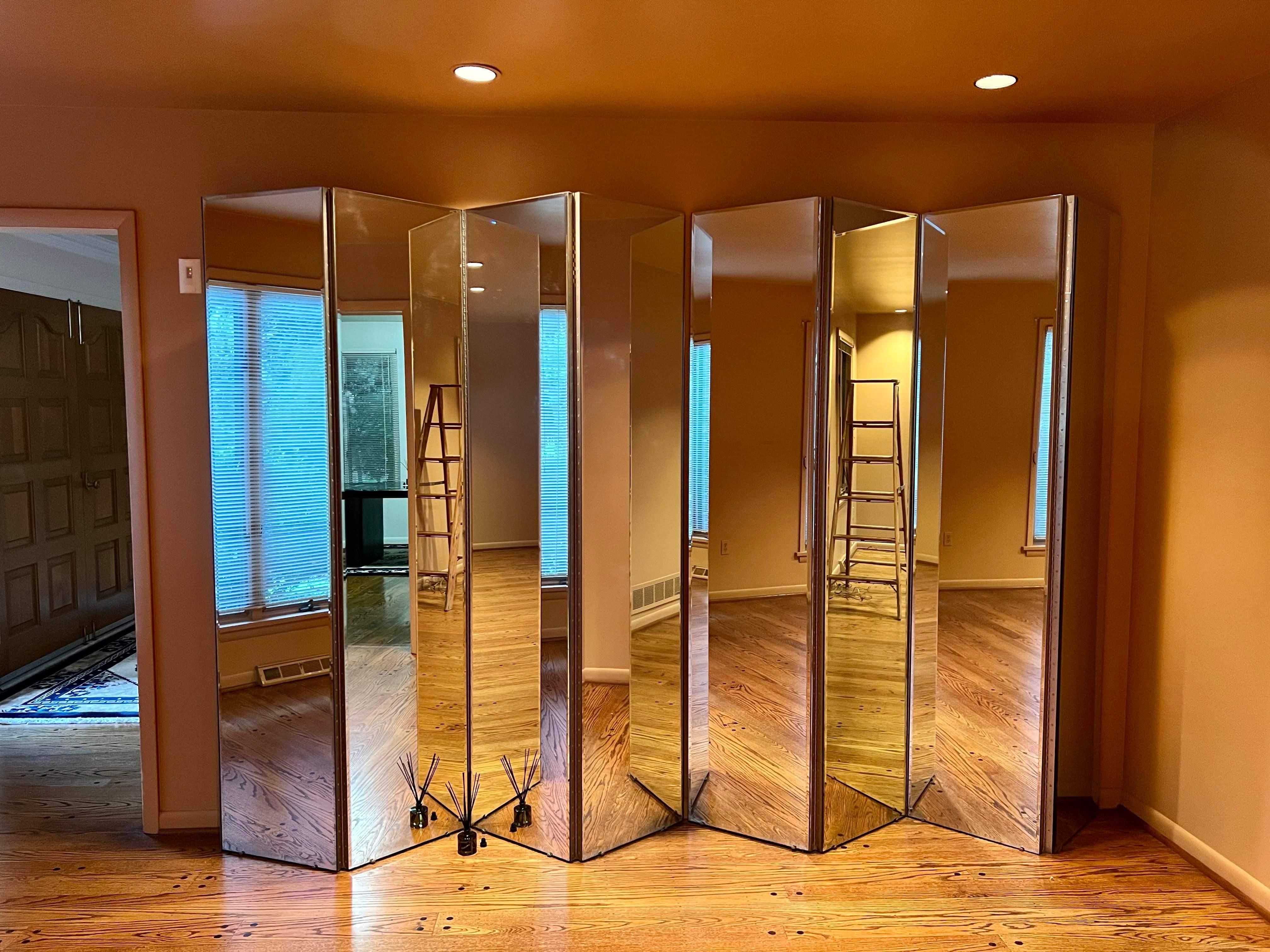 1980s hinged mirror room dividers this is 2 sets of 4 panels each these are in perfect condition no chips or breaks they were never moved til we acquired them each panel is 18�” wide