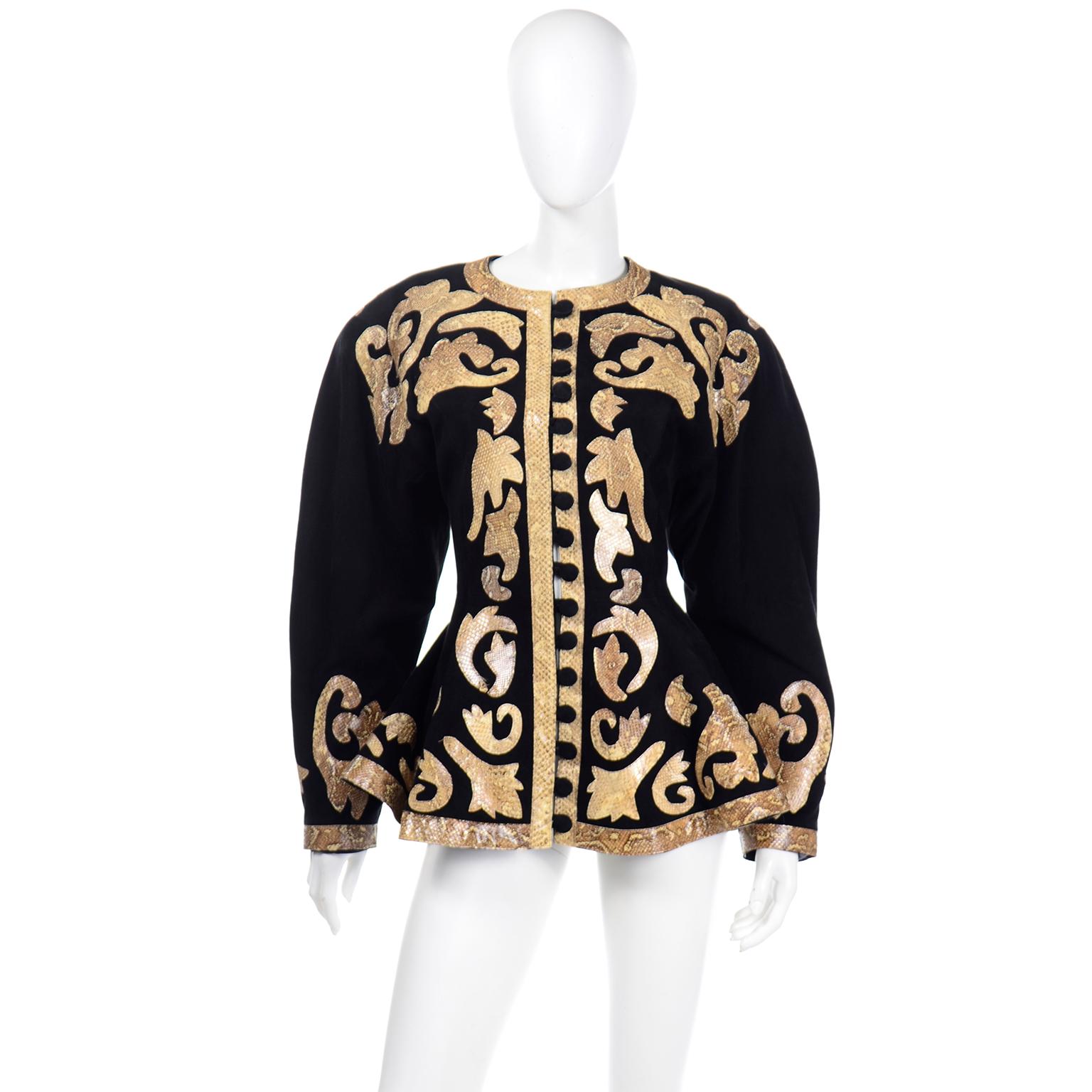 This is an absolutely stunning vintage black suede jacket with fabulous python snakeskin baroque appliques and fabric covered black buttons up the front. The jacket has the 1980's rounded oversized shoulders, a round neck, and a fitted waist with a
