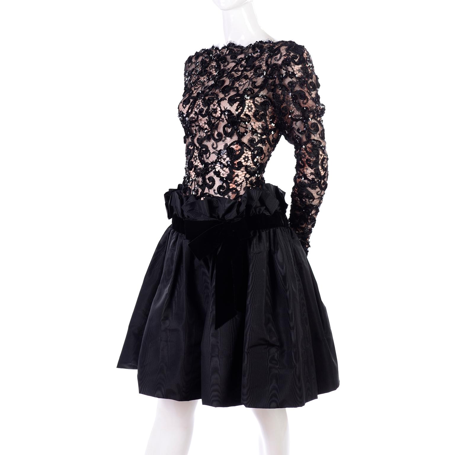 This is an absolutely gorgeous Bob Mackie vintage black dress from the 1980's. The lace illusion bodice has a tan lining and is adorned with sequins and ribbons, with eyelash scalloped edges. There is a drop paper bag style waist and the skirt