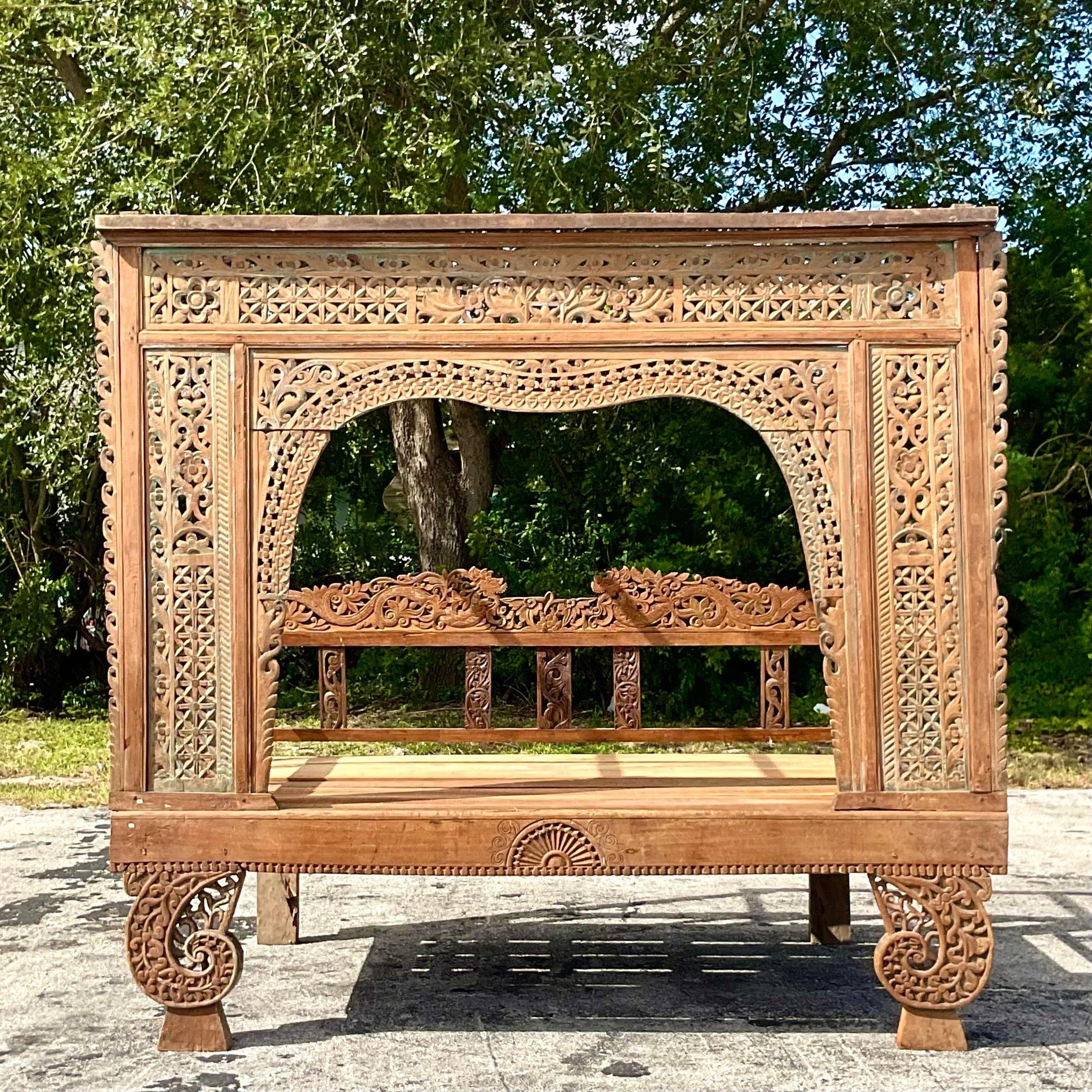 A fabulous vintage Boho Opium bed. A chic hand carved teak forms with faded hand painted detail. A special private hideaway. Acquired from a Palm Beach estate.