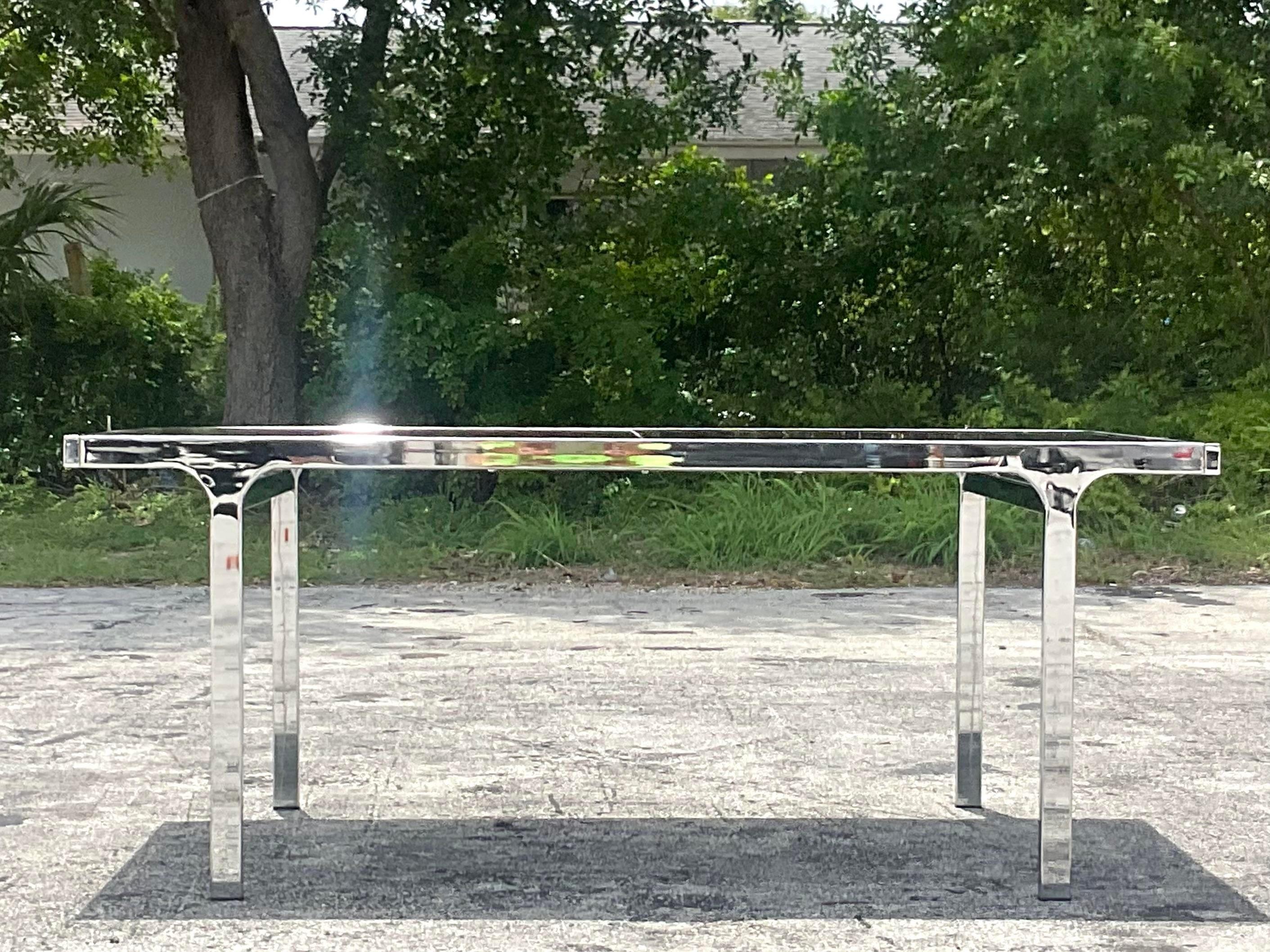 An exceptional vintage Boho dining table. Made by the Pierre Cardin group in the 80s and signed along the frame. Inset smoked glass top. Easily extends to 93.5. Acquired from a Palm Beach estate.