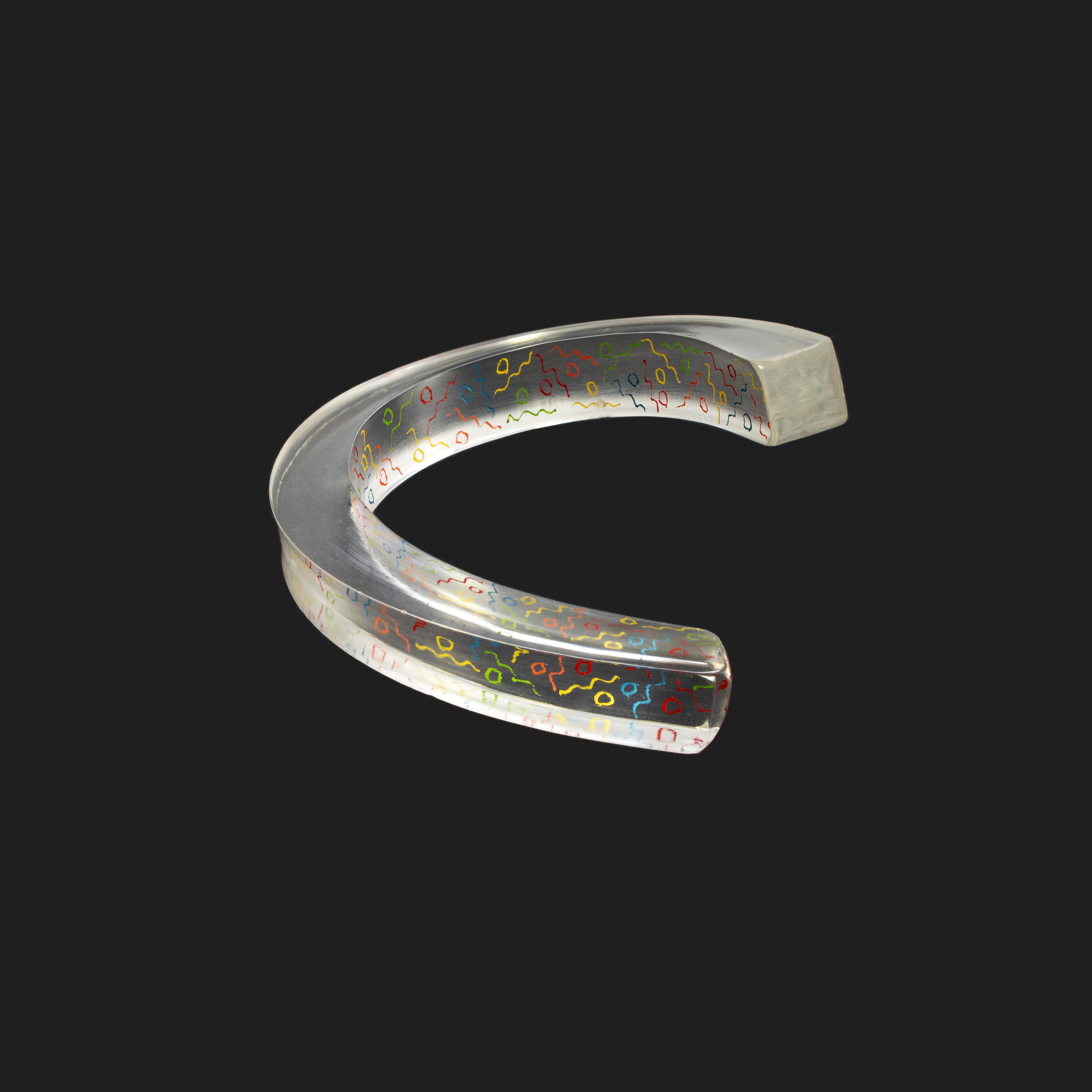 Product Details: 1980s Vintage - Bracelet - RARE - Clear Perspex + Multicoloured Geometric Inner Pattern - Asymmetric Shape -
Materials: Clear Perspex + Multicoloured Geometric Inner Pattern 
Depth: 1.2 cm
Length: 16 cm
Condition: Good Condition /