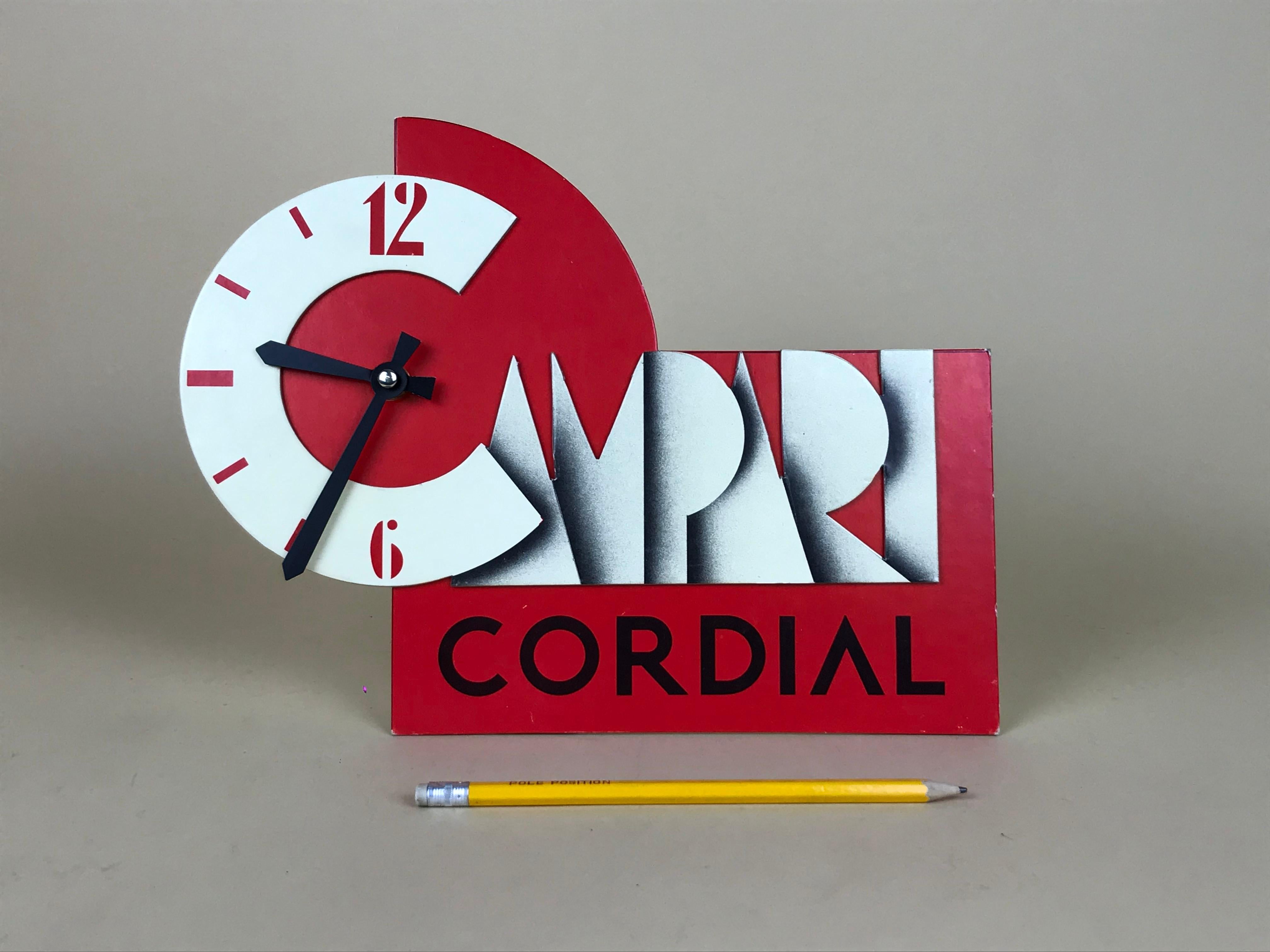 Vintage Campari cordial clock in cardboard and quartz movement made in Italy in the 1980s.

The clock is a reproduction from an original version of the 1930s with artwork probably by Nicolay Diulgheroff or Fortunato Depero.

The clock in powered