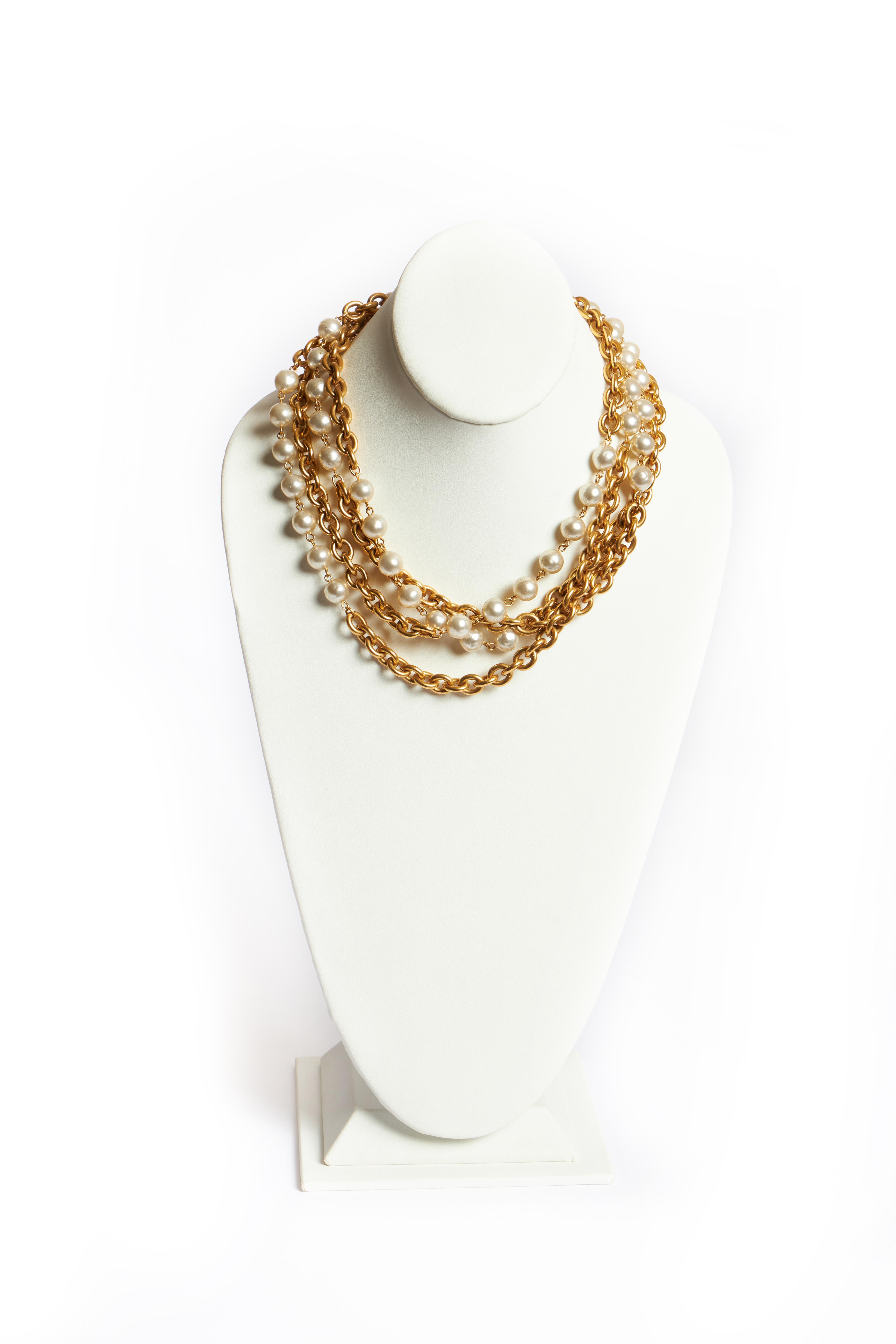 Chanel gold tone metal double-strand necklace accented with pearl glass beads. Can be worn single or double. Comes with original duster or box.