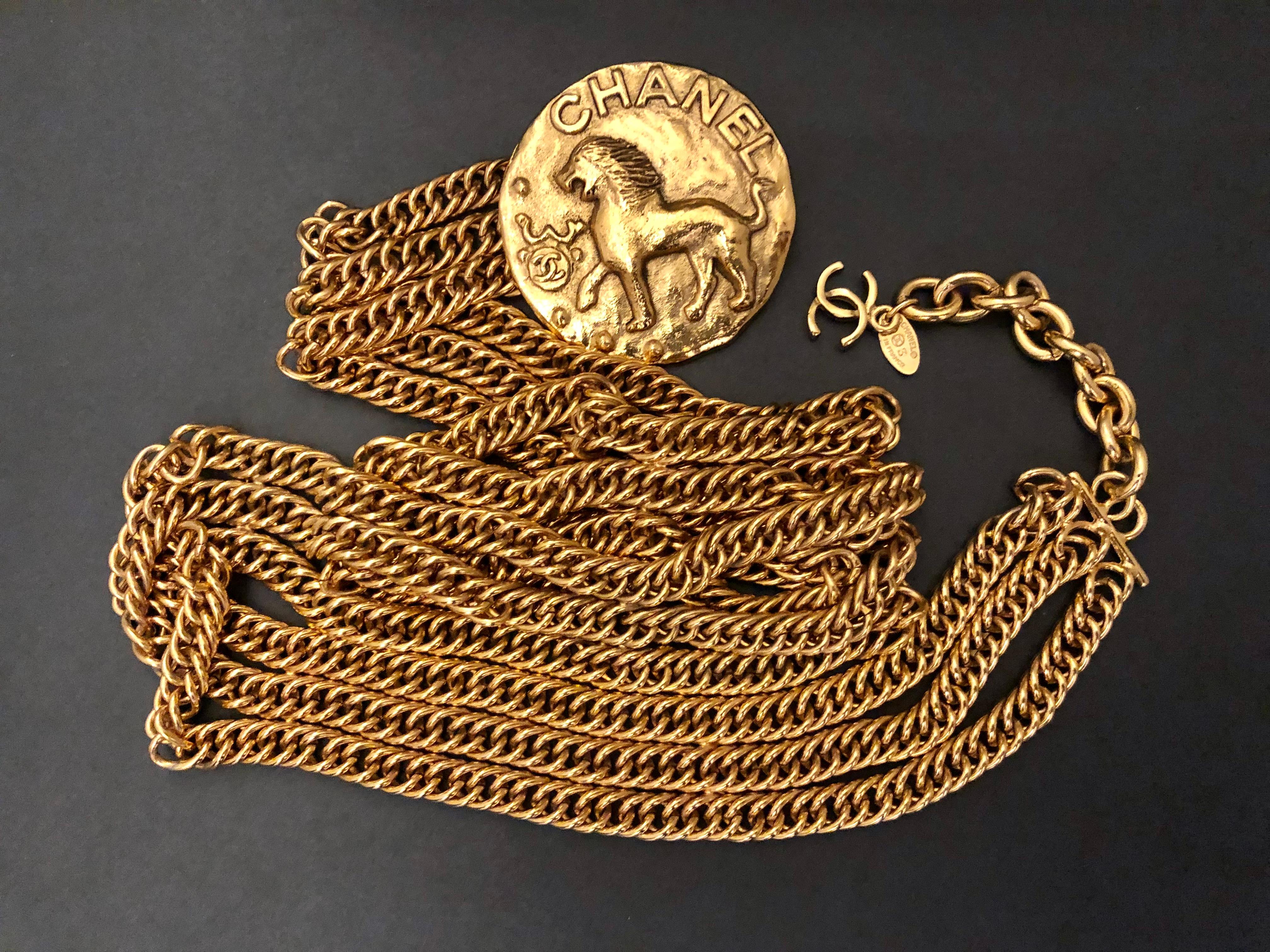 This vintage CHANEL chain belt is crafted of gold toned chains in triple strands adorned with a Byzantine Lion medallion charm. Stamped CHANEL 2 3 made in France. Adjustable hook fastening with a CC dangle charm. Total length measures approximately