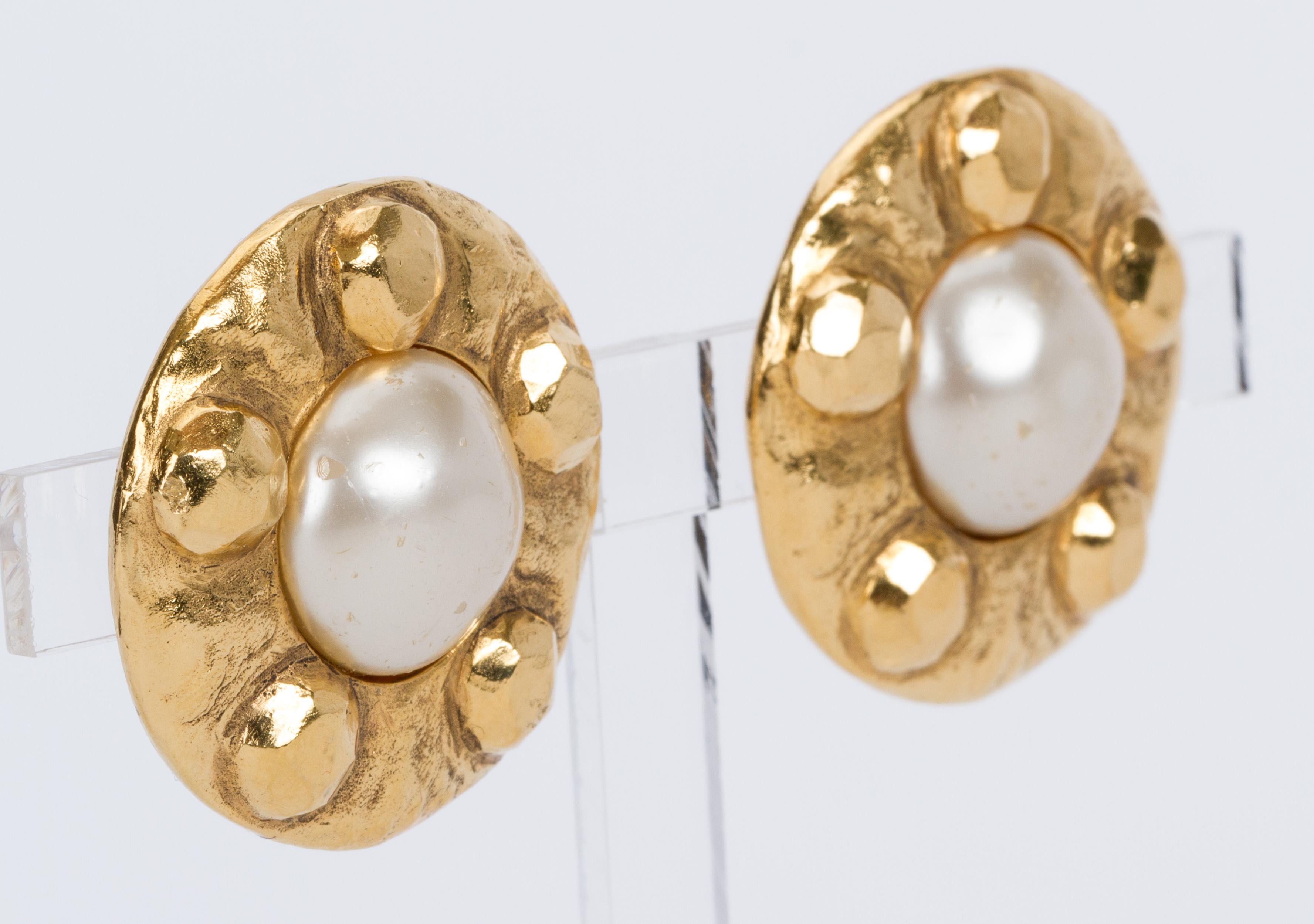 Chanel hammered goldtone metal and faux-pearl clip-back earrings. Comes with the original box or dust cover. Minor scuffs on faux-pearls.

