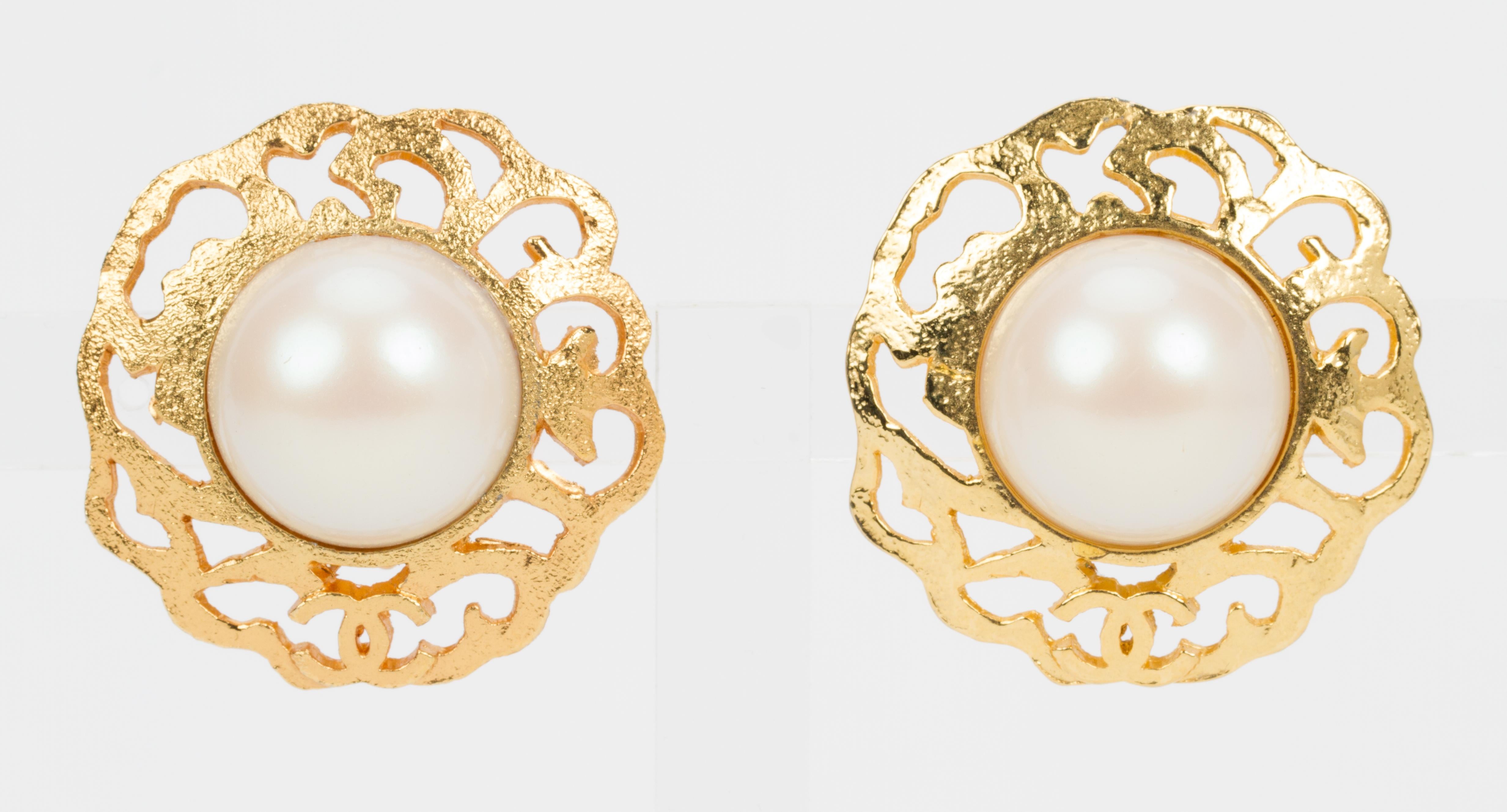 Chanel large satin gold clip earrings with faux mabe pearls center. Collection 25. Comes with original pouch.