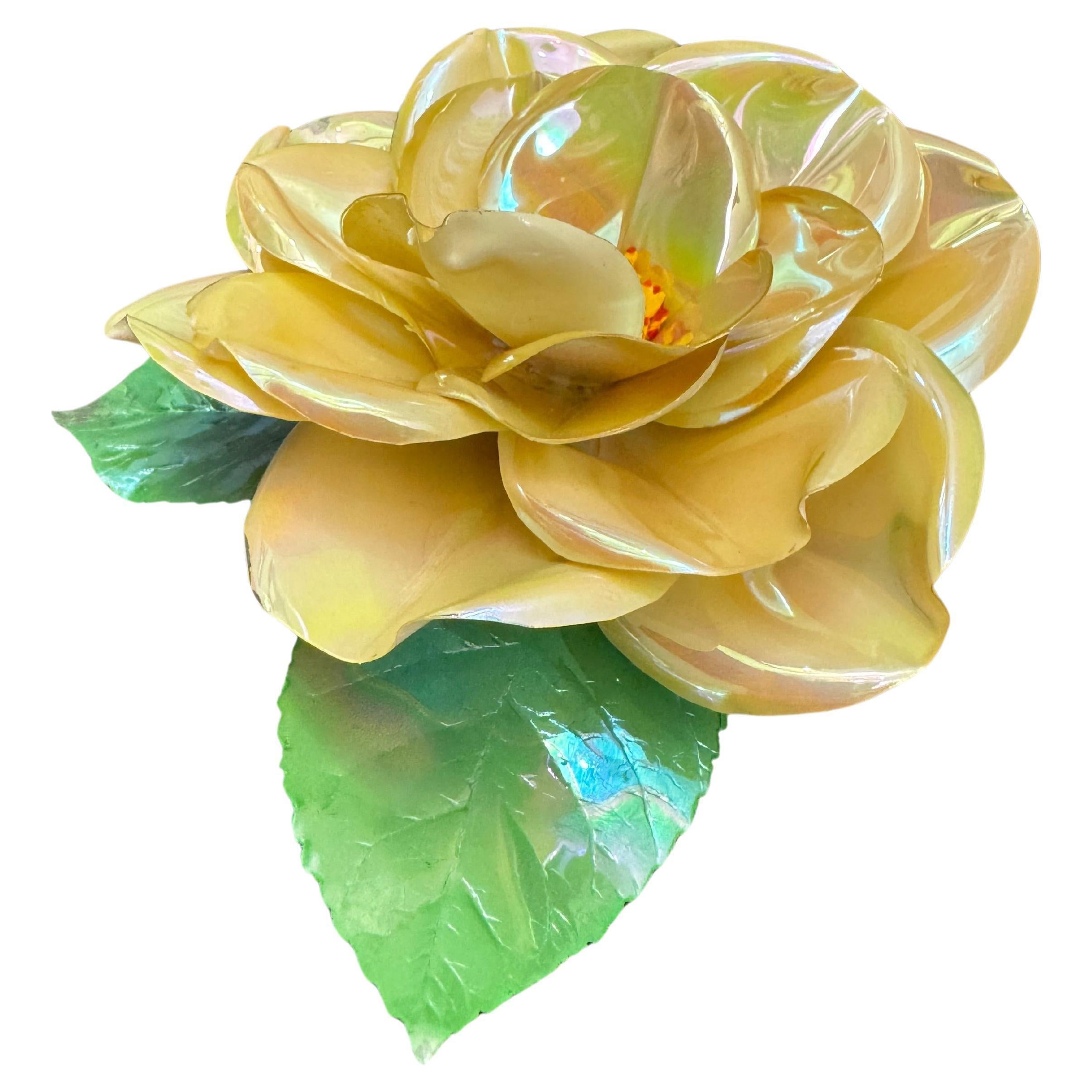 This vintage CHANEL massive camellia brooch is crafted of coated vinyl petals in iridescent cream color. Stamped CHANEL made in France. Measures approximately 5 cm in diameter. Comes with box. 

Condition: Good vintage condition with minor peelings