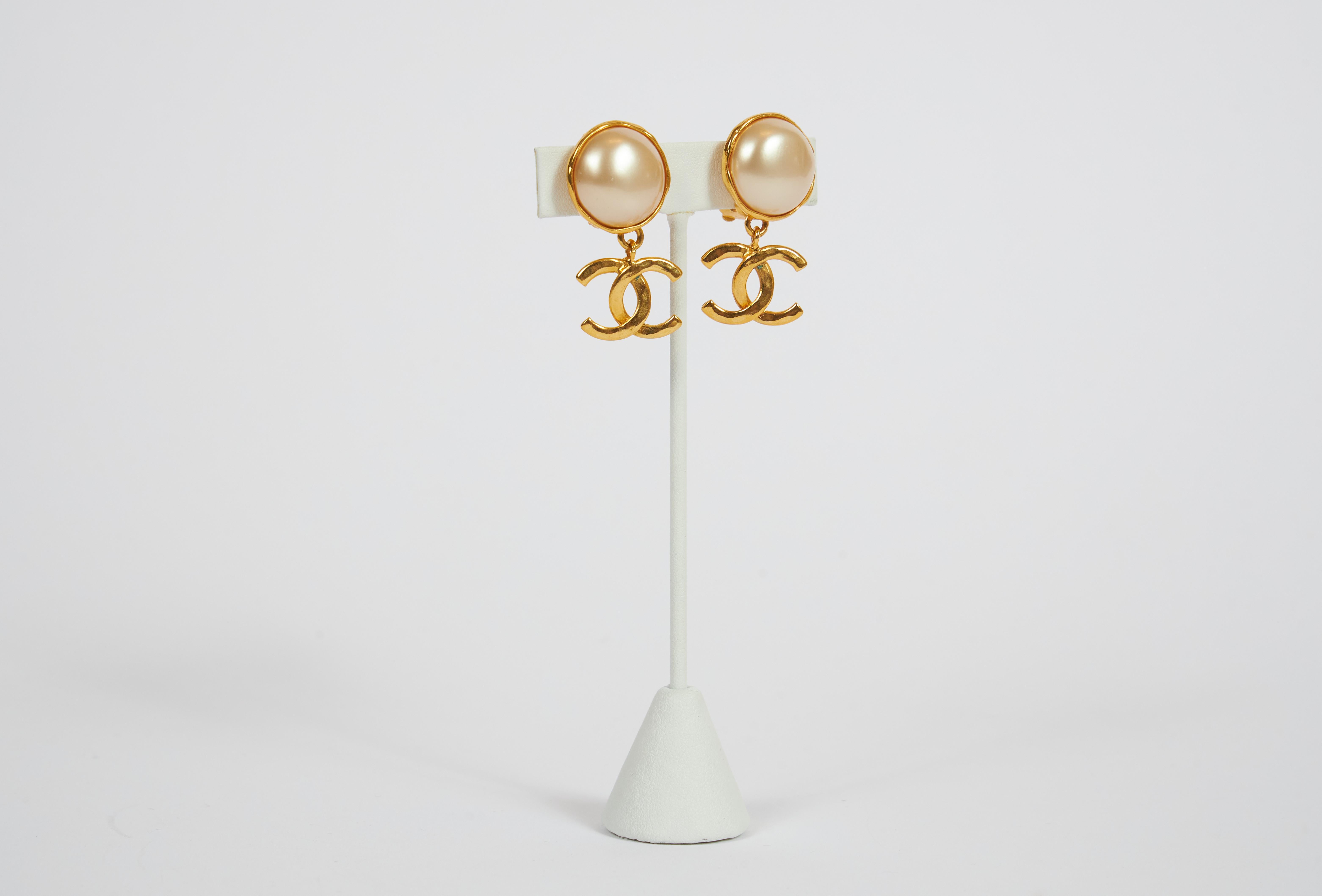 Chanel classy faux make pearl clip earrings with gold cc logo dangle. Early 80s collection. Come with original box.