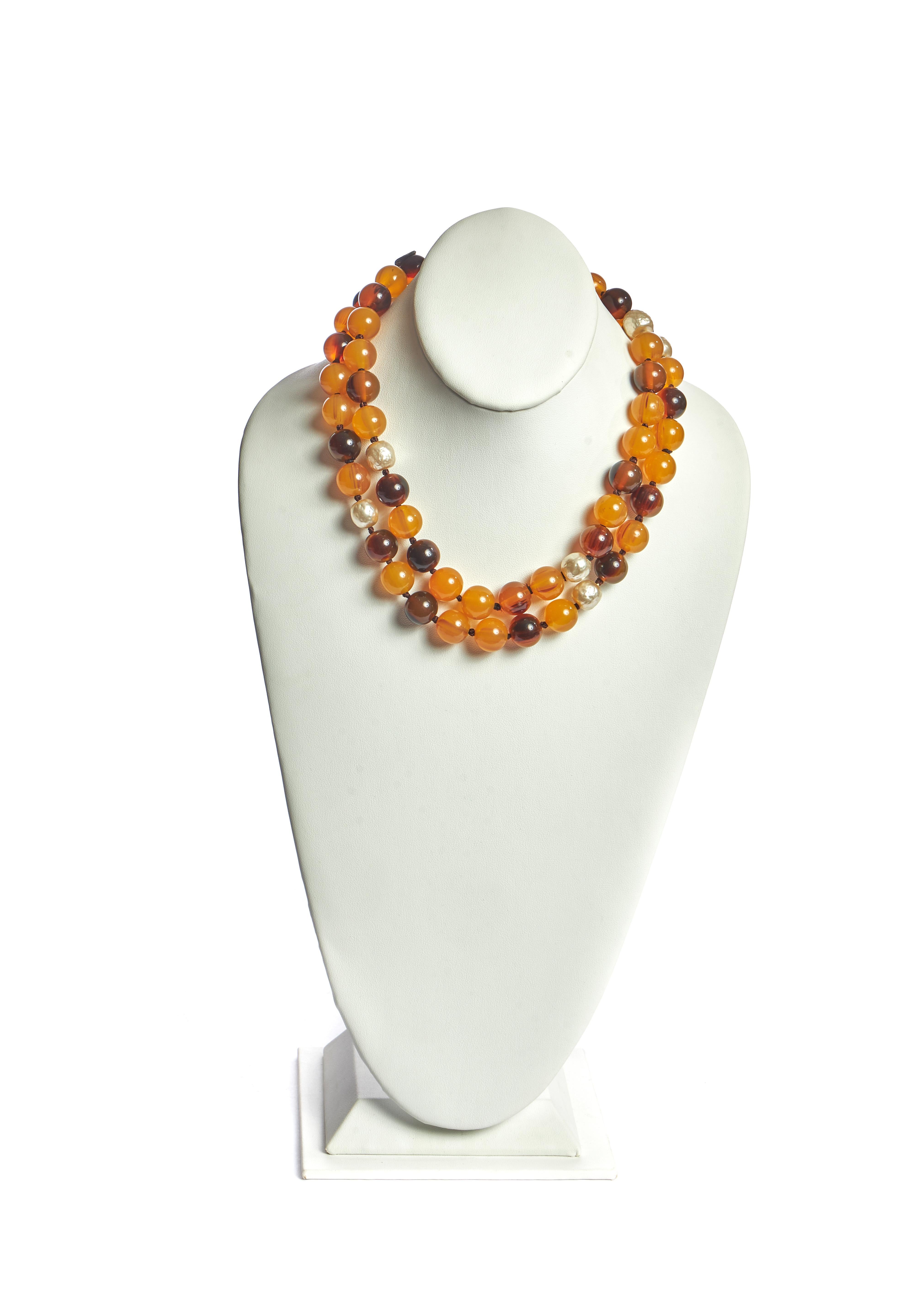 Chanel long necklace with imitation amber, pearl and tortoise beads. Collection 1985. Comes with original dust cover or box.