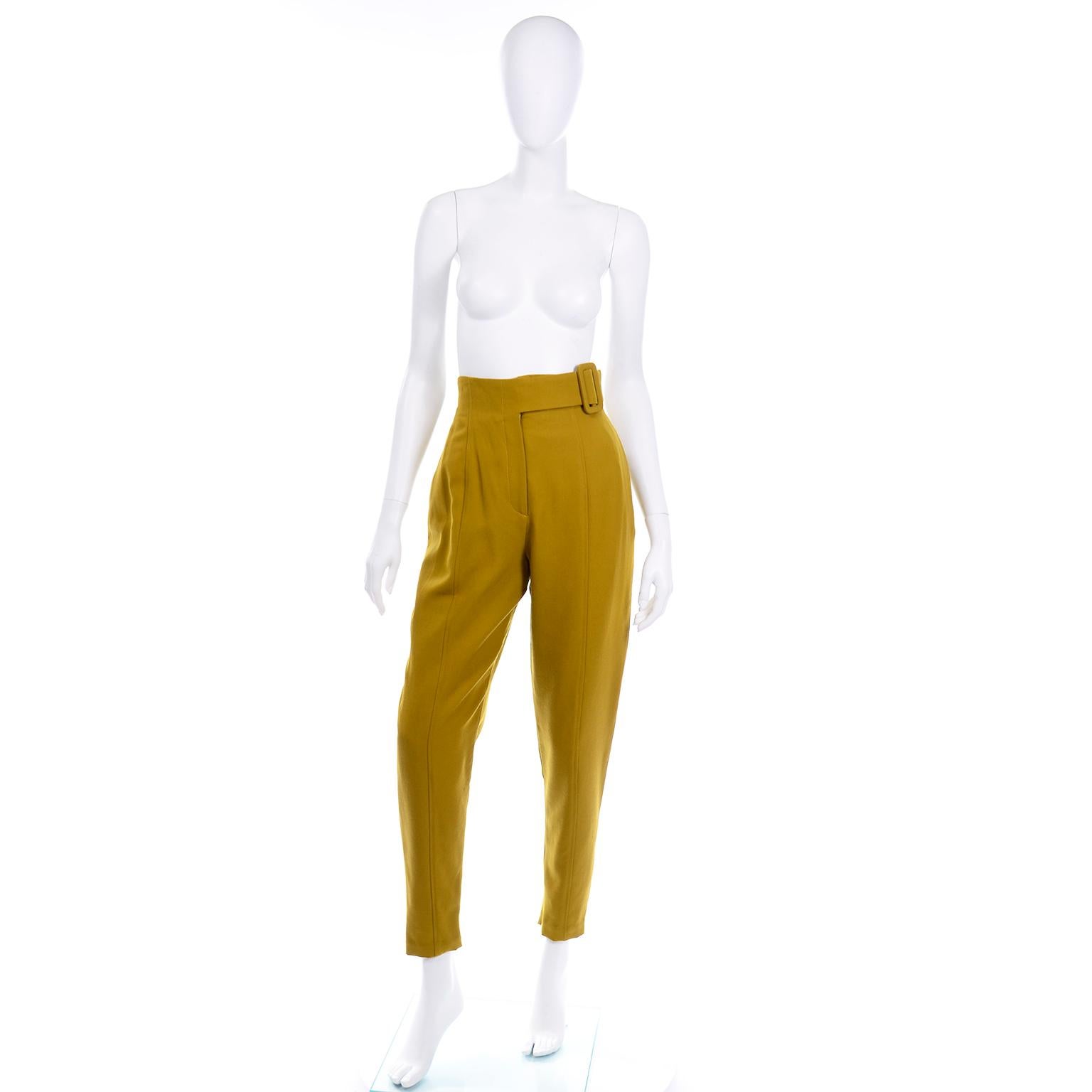We fell in love with these Incredible mustard high waisted wool trousers with a faux side waist belt. The belt is attached to the waistband and is secured with hook and eye closures on the side of the waist. The pants are also secured with a flat