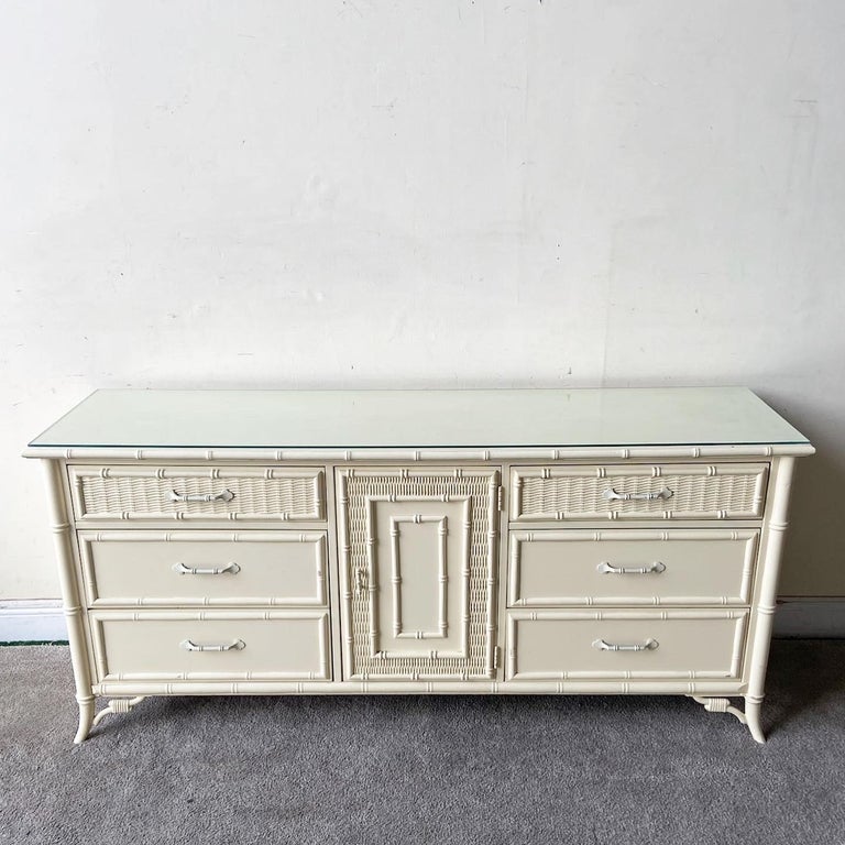 Incredible vintage coastal regency dresser by Stanley furniture. Features a cream finish with a glass top.
 