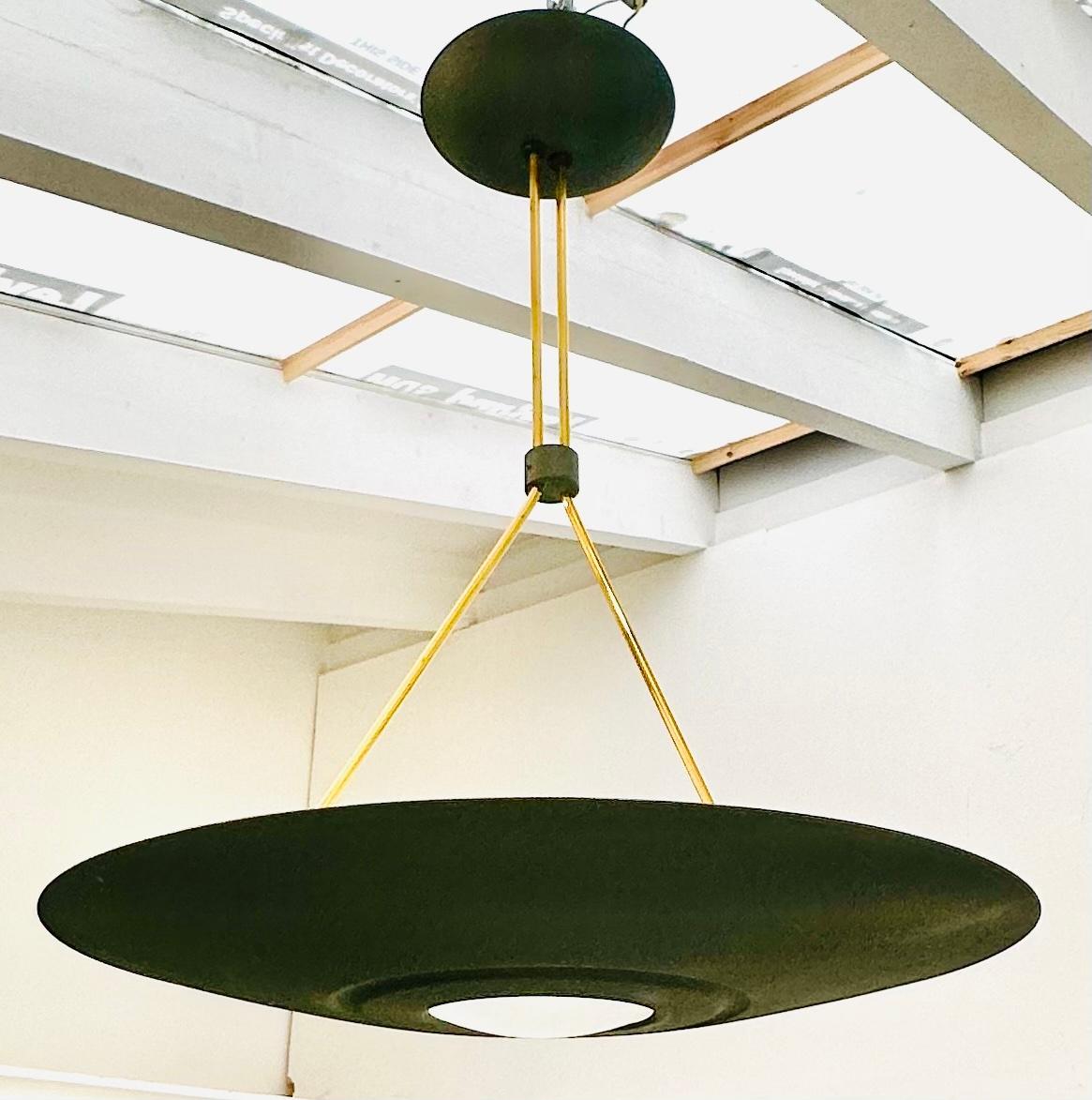1980s French UFO-shaped, space age, directional uplighter halogen ceiling light.  Manufactured by L G Paris. The metal curved shade is coated with a dark green textured enamel coating on the outside with a matching ceiling cup with the same coating.