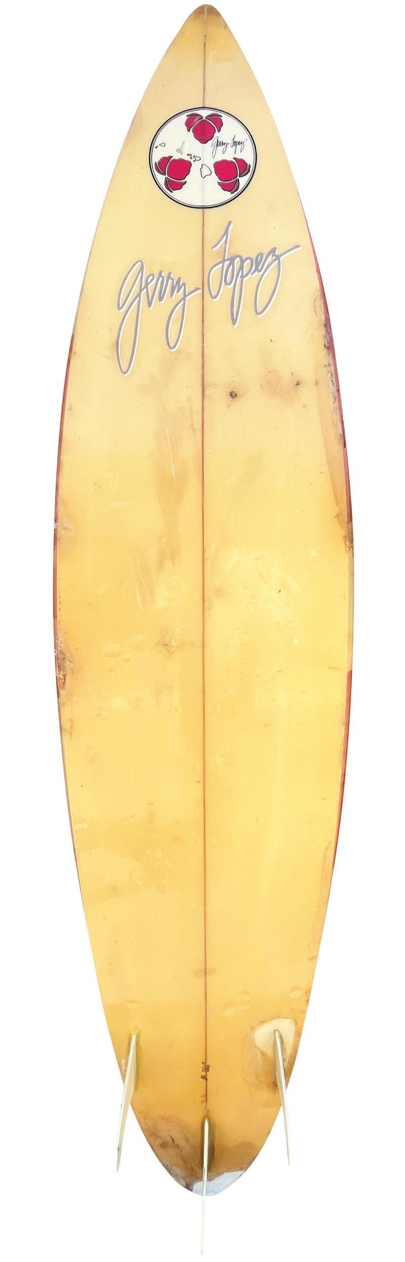Late-1980s Gerry Lopez shaped thruster surfboard. Features an iconic camouflage airbrush pattern which Lopez boards were known for in the 1980s-90s. Hand signed by Gerry Lopez, “GL” which indicates the surfboard was handmade by Gerry Lopez and not