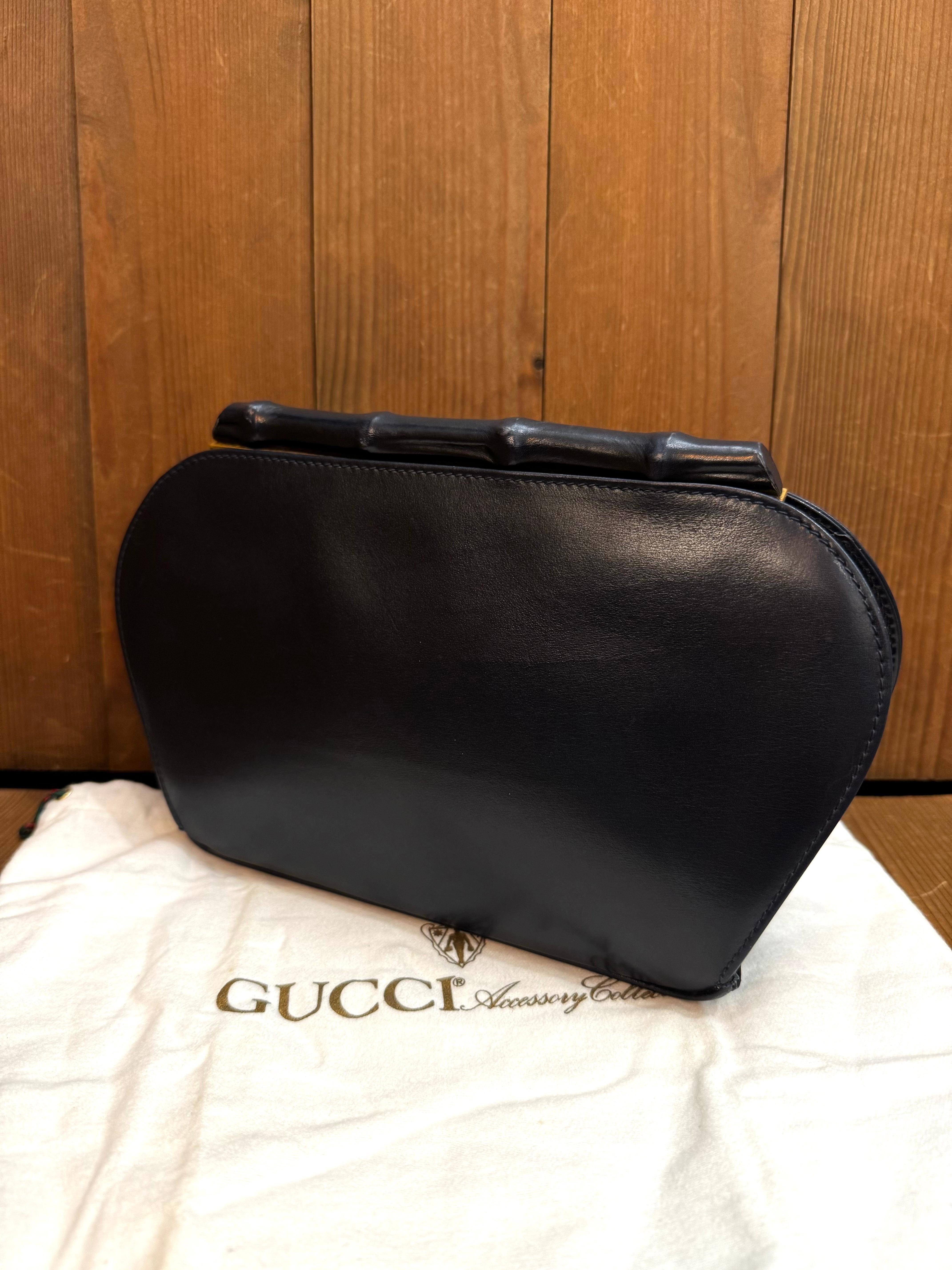 This vintage GUCCI evening clutch bag is crafted of smooth calfskin leather in navy featuring a bamboo top covered with the same leather. Top kiss lock closure opens to a luxurious diamond quilted suede interior embroidered with a massive GUCCI