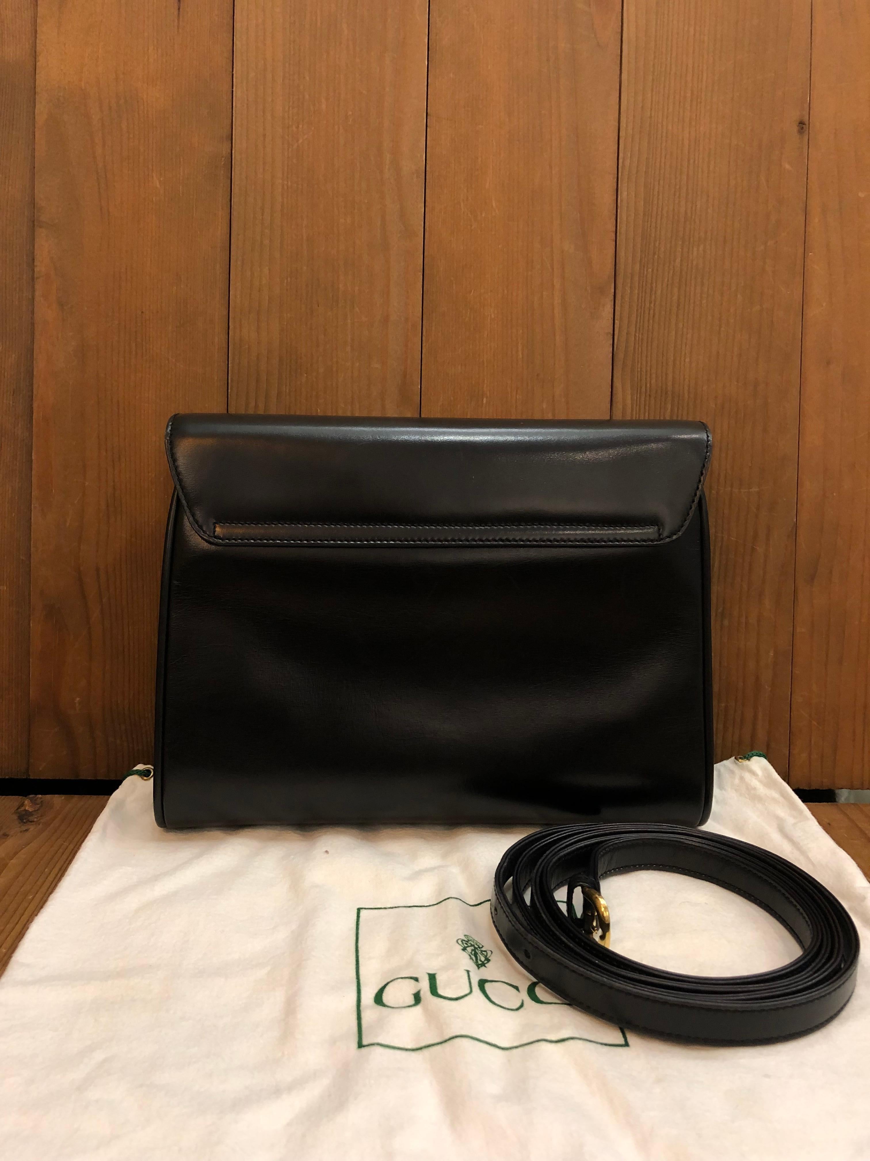 This vintage GUCCI two-way clutch/crossbody bag is crafted of smooth calfskin leather in black featuring gold toned hardware. Gucci Crest magnetic snap closure opens to a black suede interior featuring a zippered pocket. This vintage Gucci also