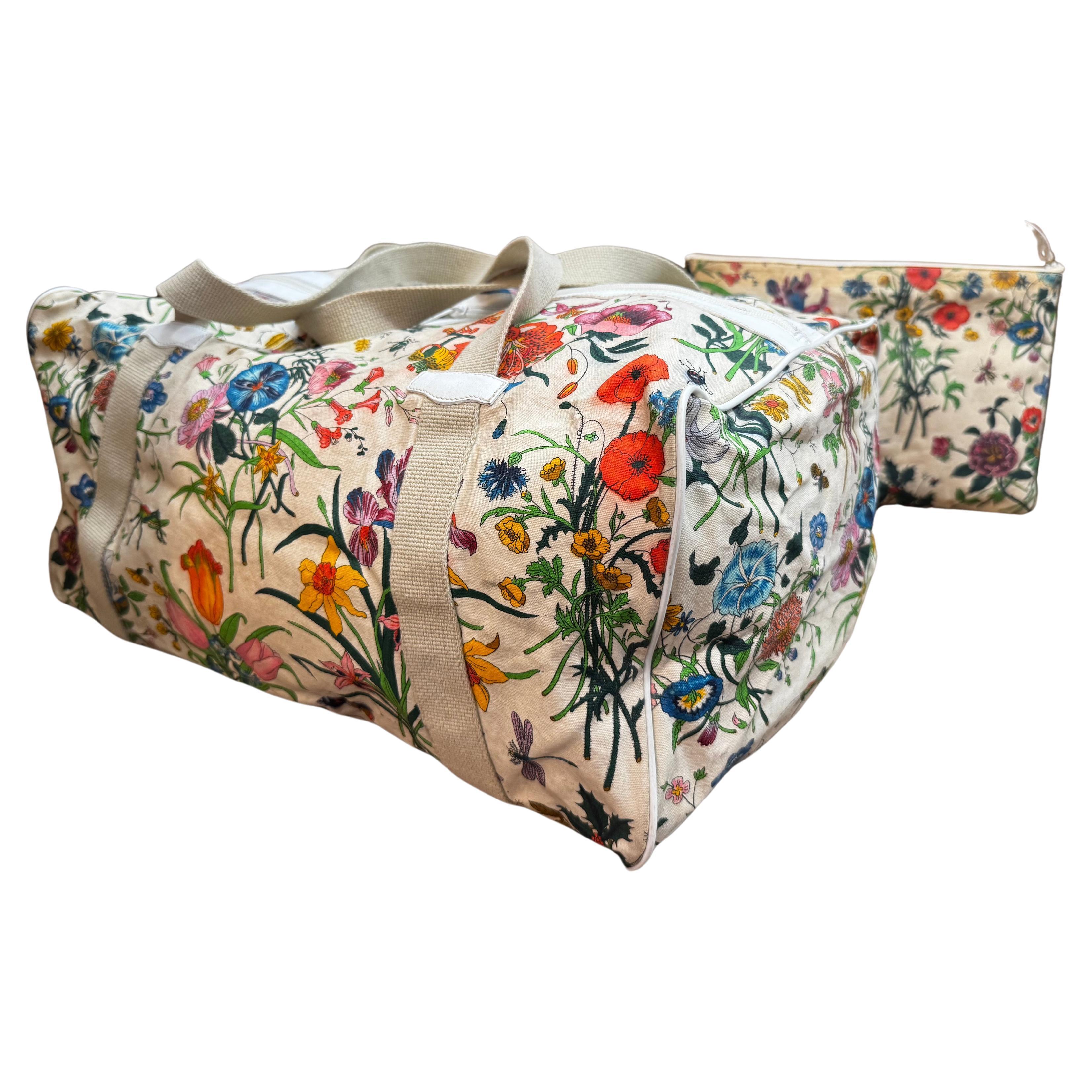 This rare vintage Gucci duffle bag is crafted of Gucci’s iconic floral canvas in off-white and smooth white calfskin leather featuring sturdy canvas handles. Top zipper closure opens to a spacious interior which has been professionally cleaned. This