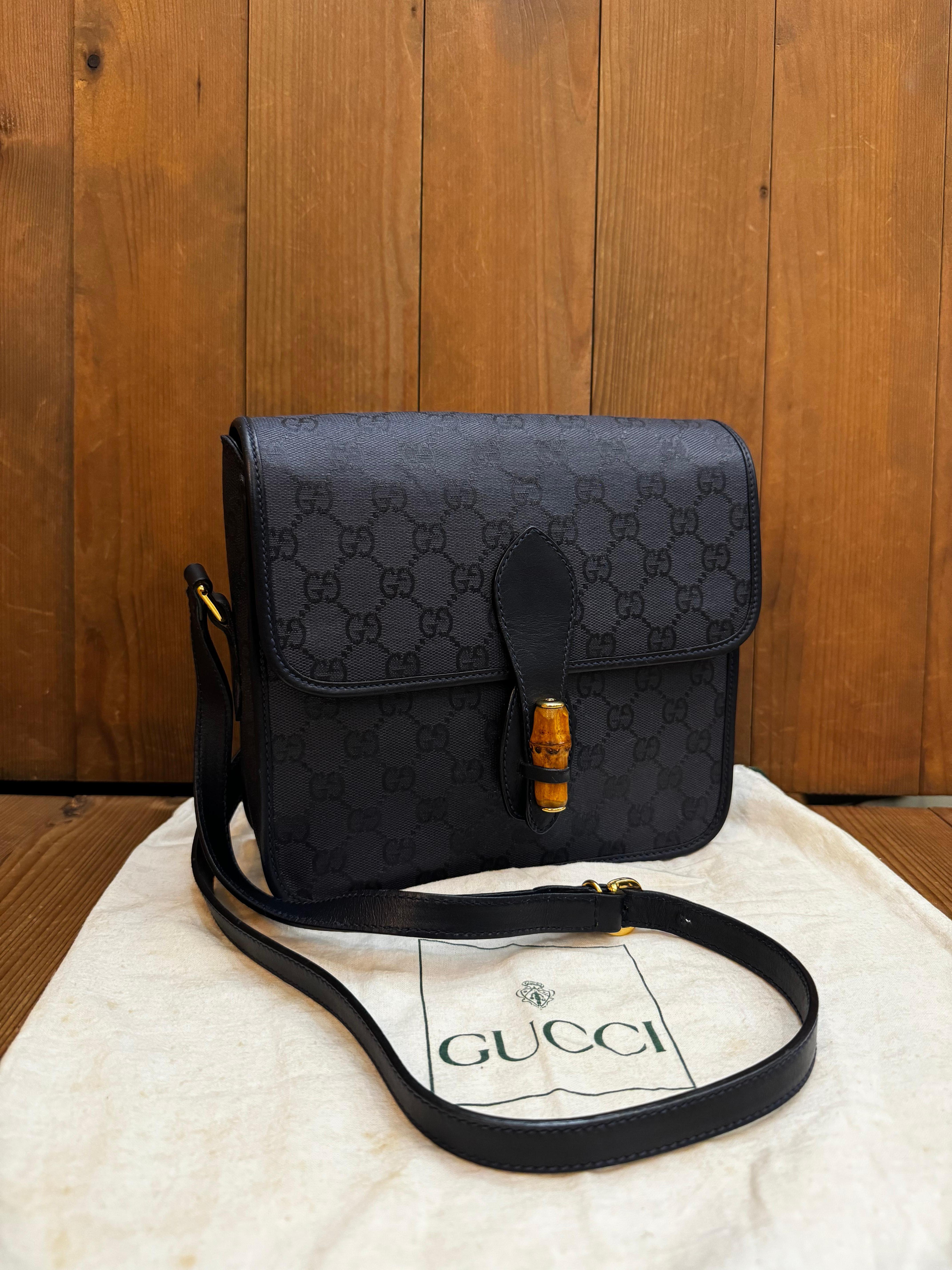 This Vintage GUCCI camera bag is crafted of GG jacquard in navy and navy smooth leather. Front bamboo magnetic snap closure opens to a leather interior in navy featuring an unlined zippered pocket. This camera bag also features a patch pocket at the