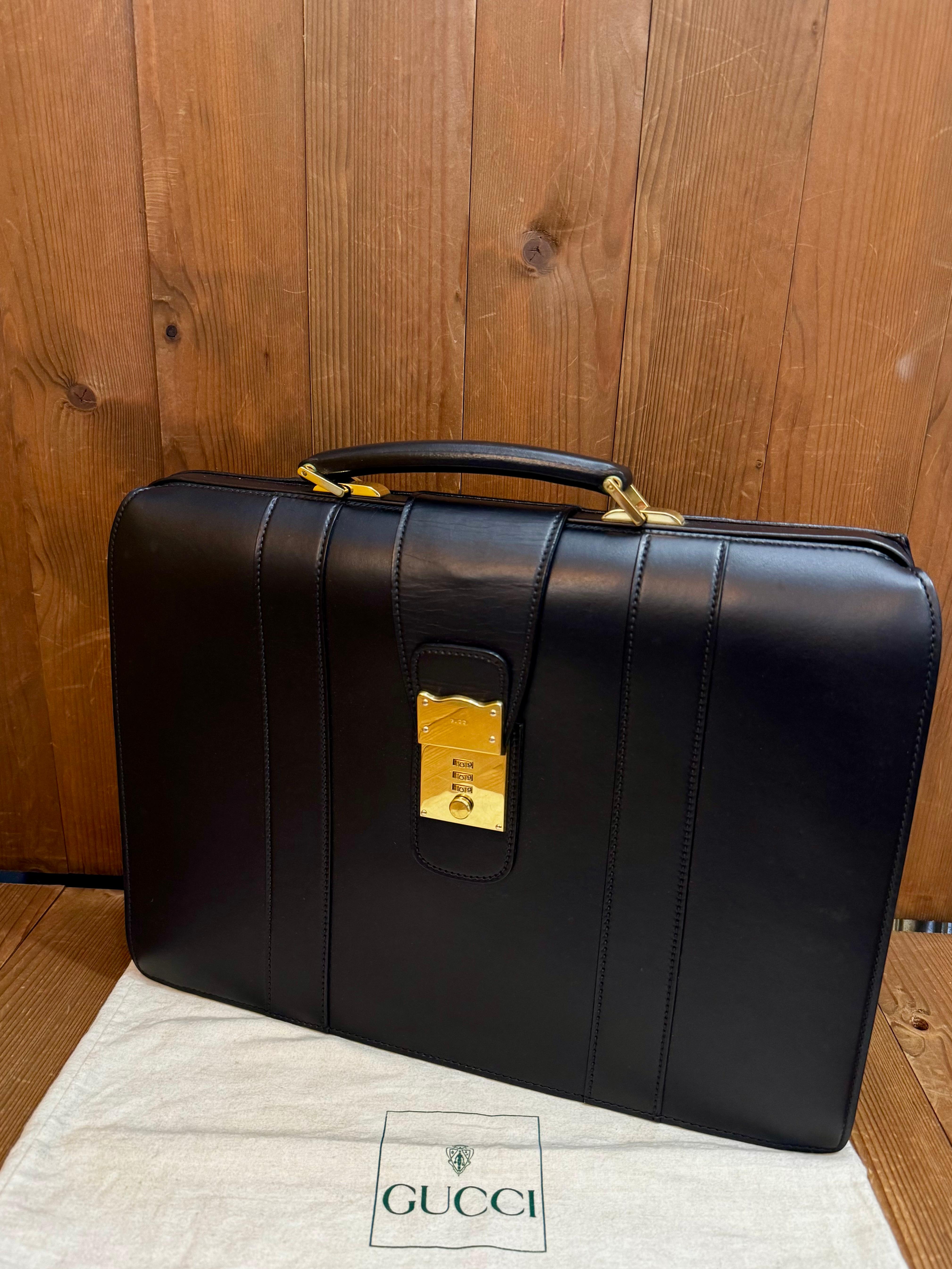 This vintage GUCCI briefcase business bag is crafted of smooth calfskin leather in black featuring gold toned hardware. Front push-lock closure open to an all leather interior in featuring a zippered pocket in the middle and slip pocket. Made in